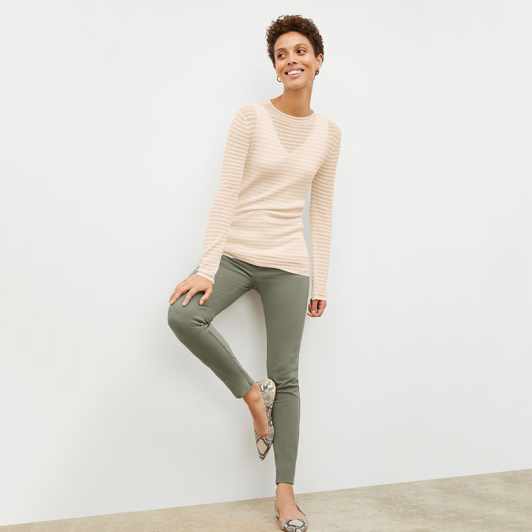 Front image of a woman wearing the skinny foster in thyme 