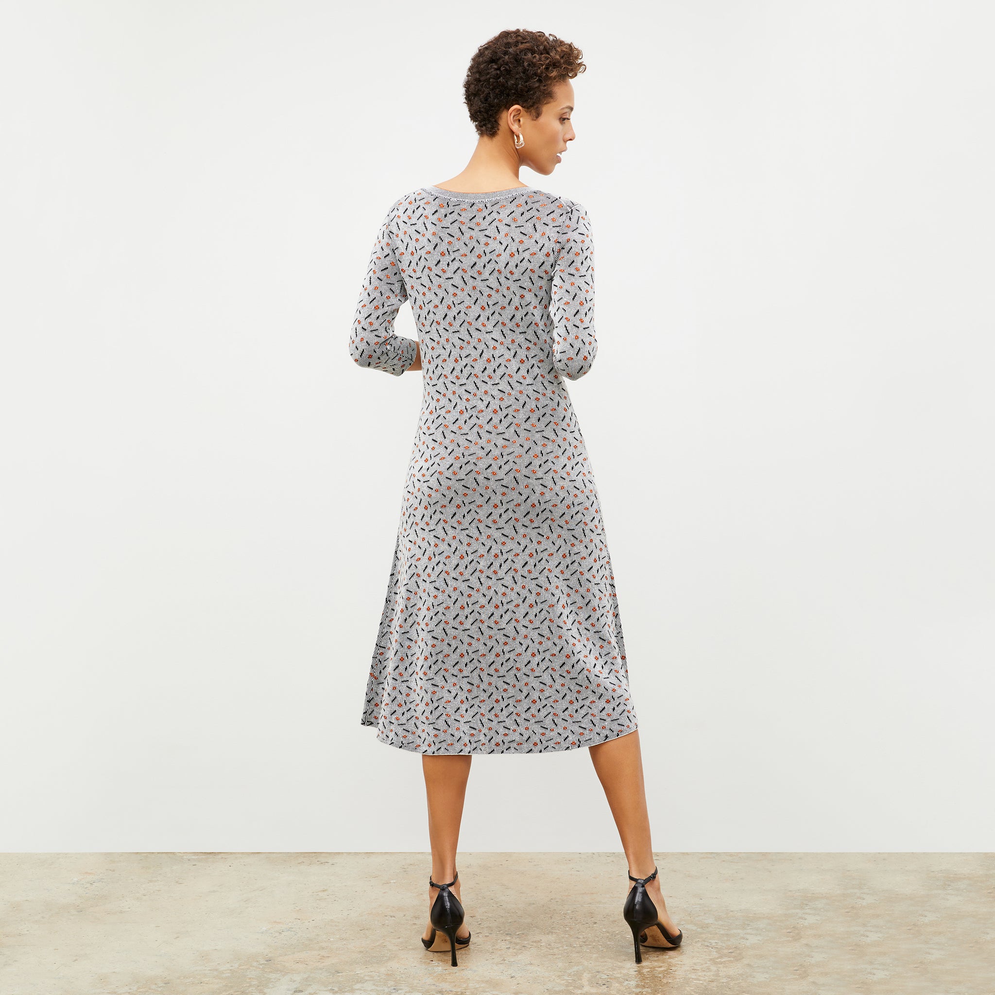 Back image of a woman wearing the Tippy Dress in Brick and Black