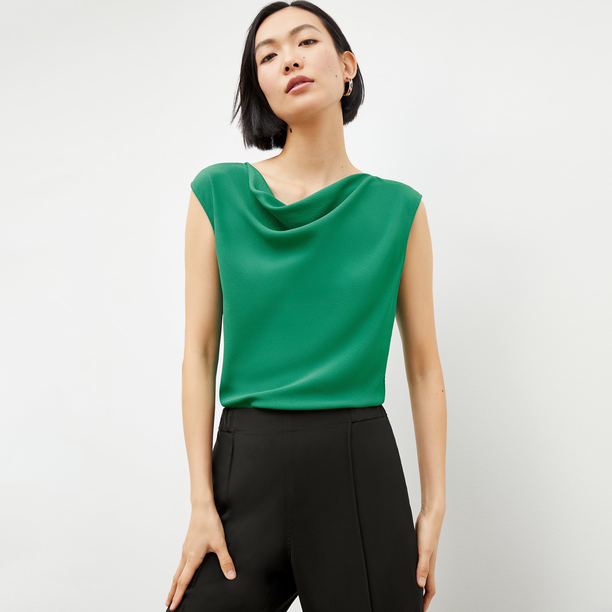 Front image of a woman in the nora top in clover 