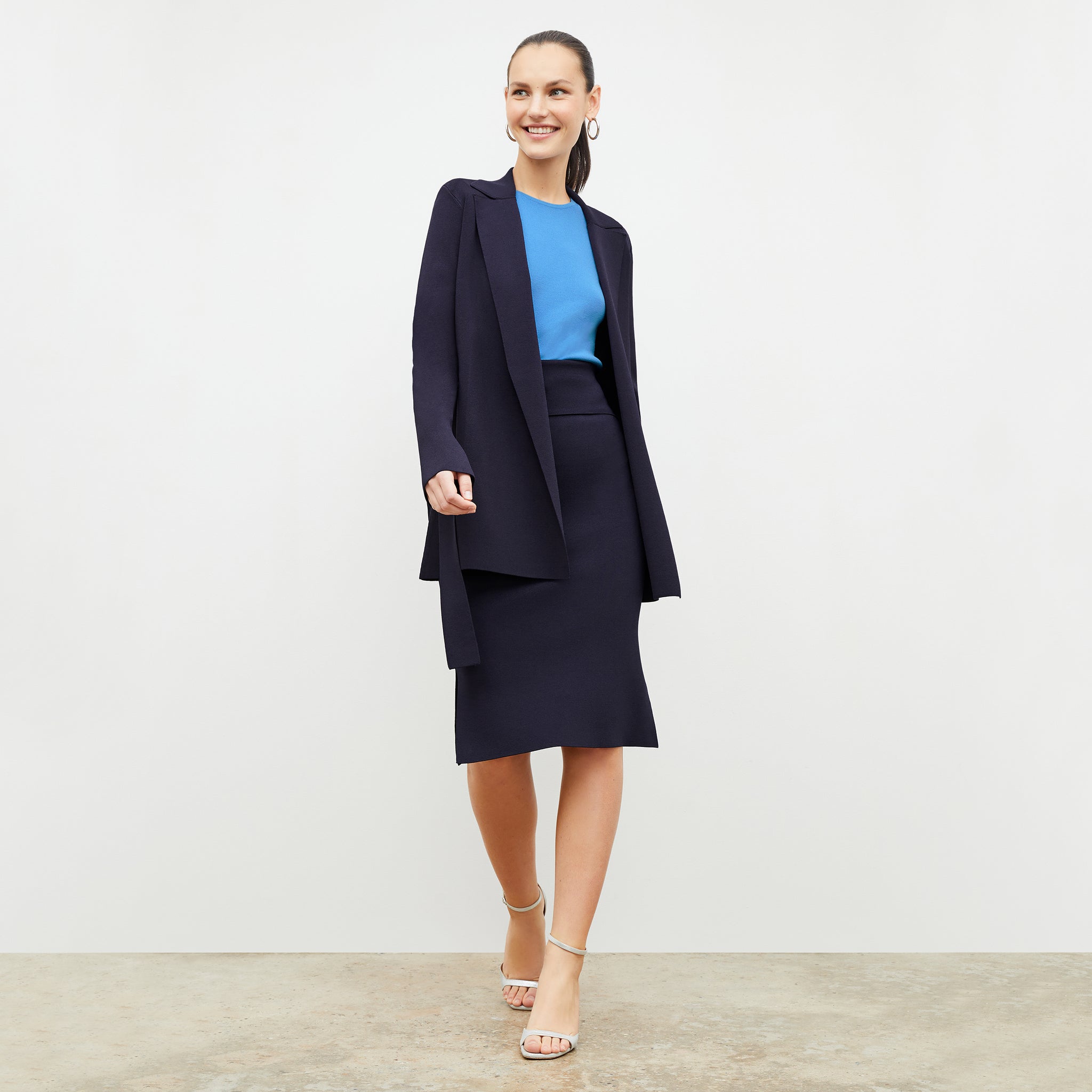 Front image of a woman wearing the harlem skirt in navy