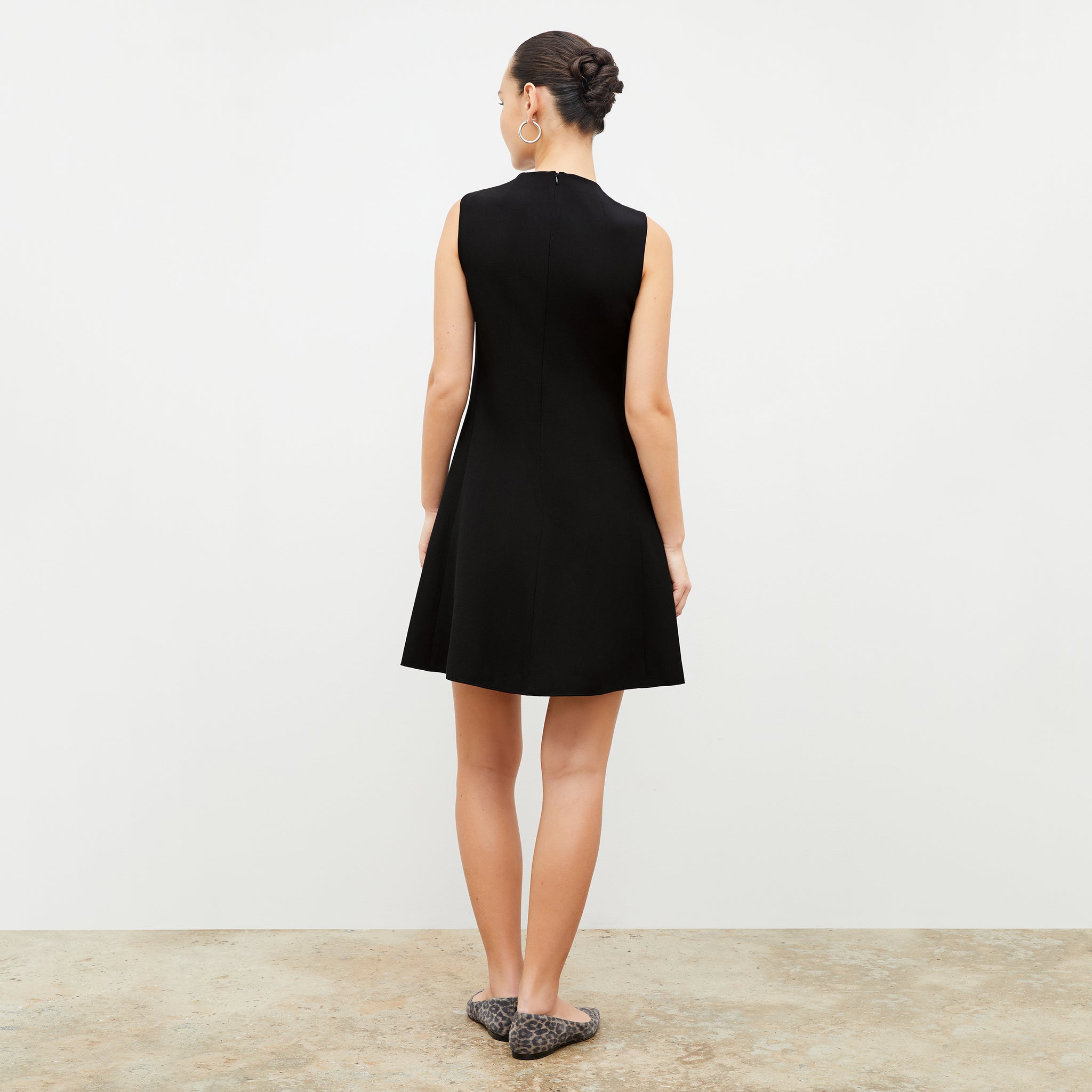 Back image of a woman in the malala dress in black