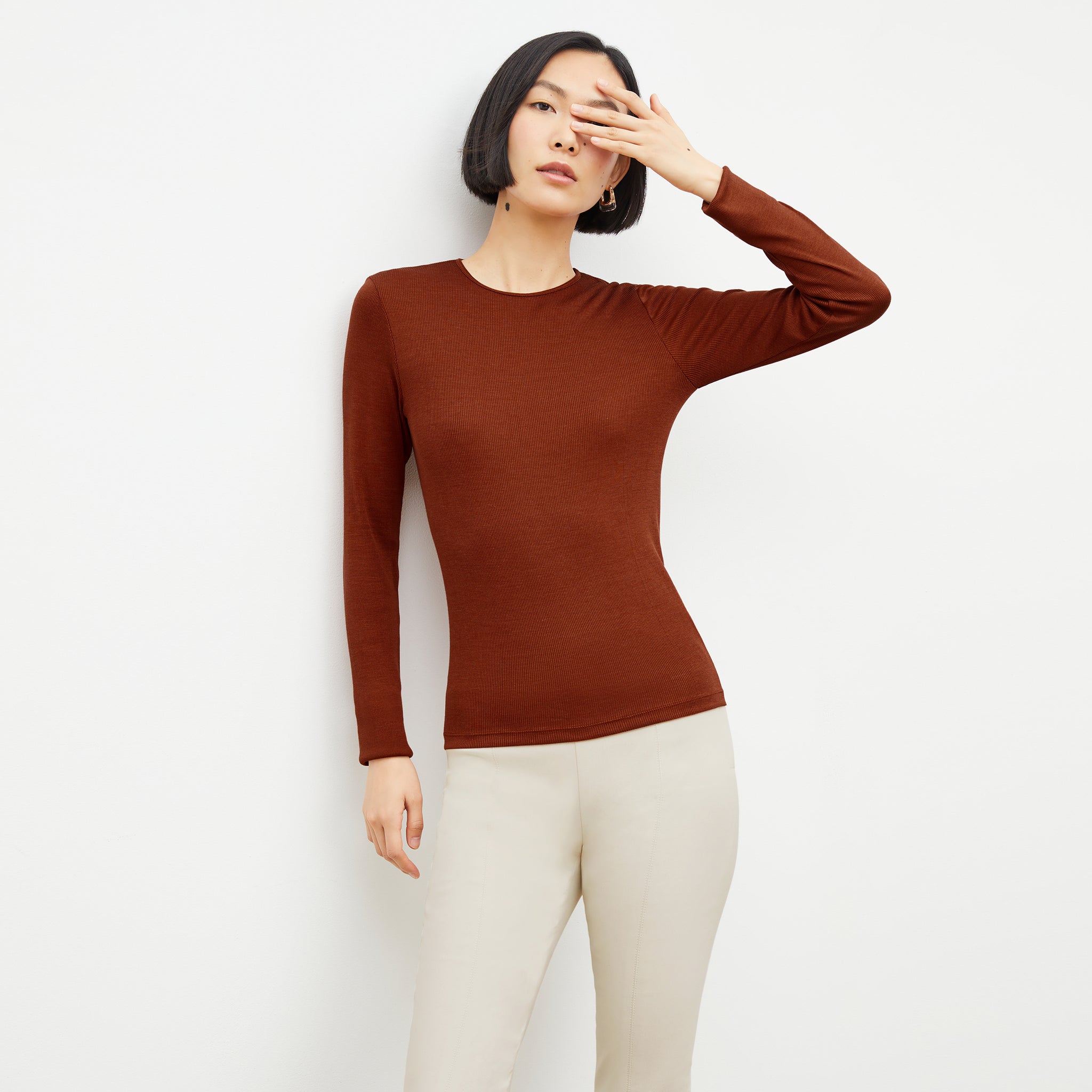 Front image of a woman wearing the malley top in Mars 