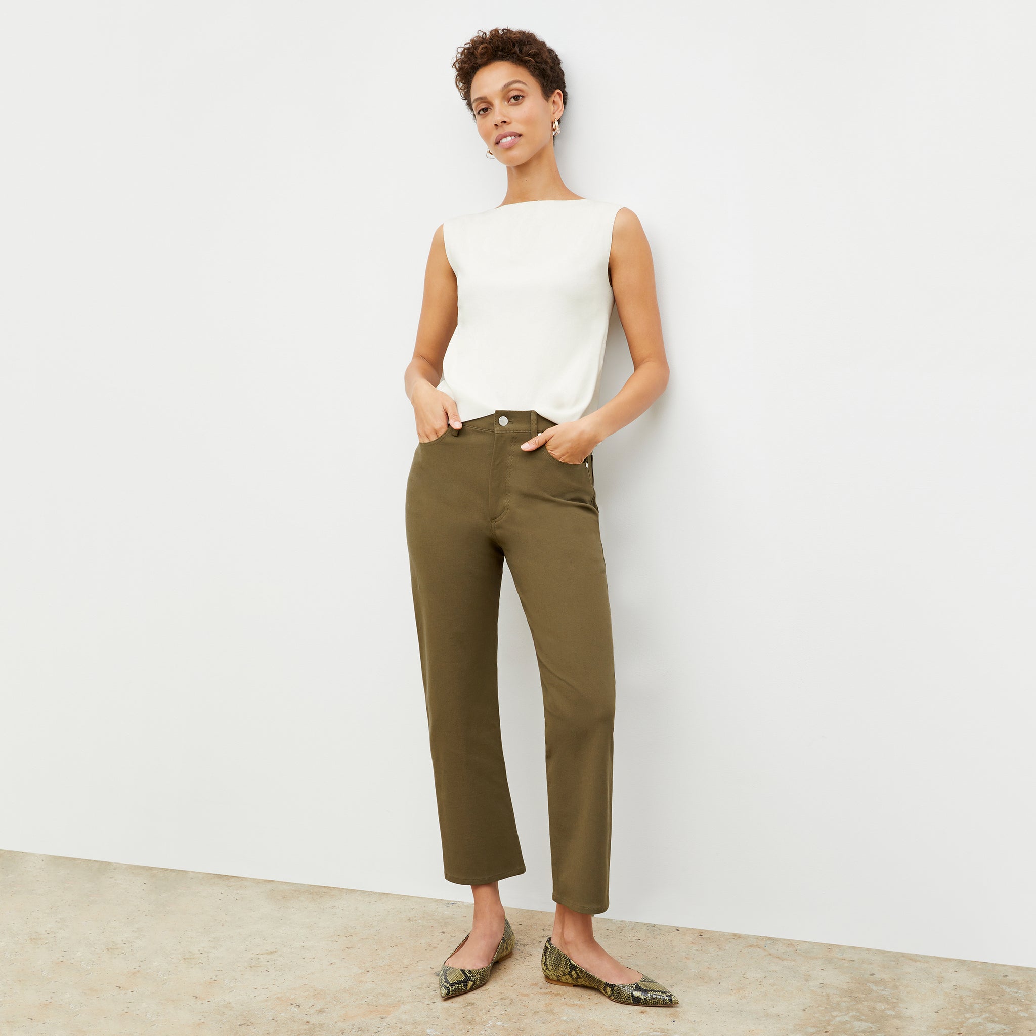 Front image of a woman standing wearing the Eileen Top in ivory