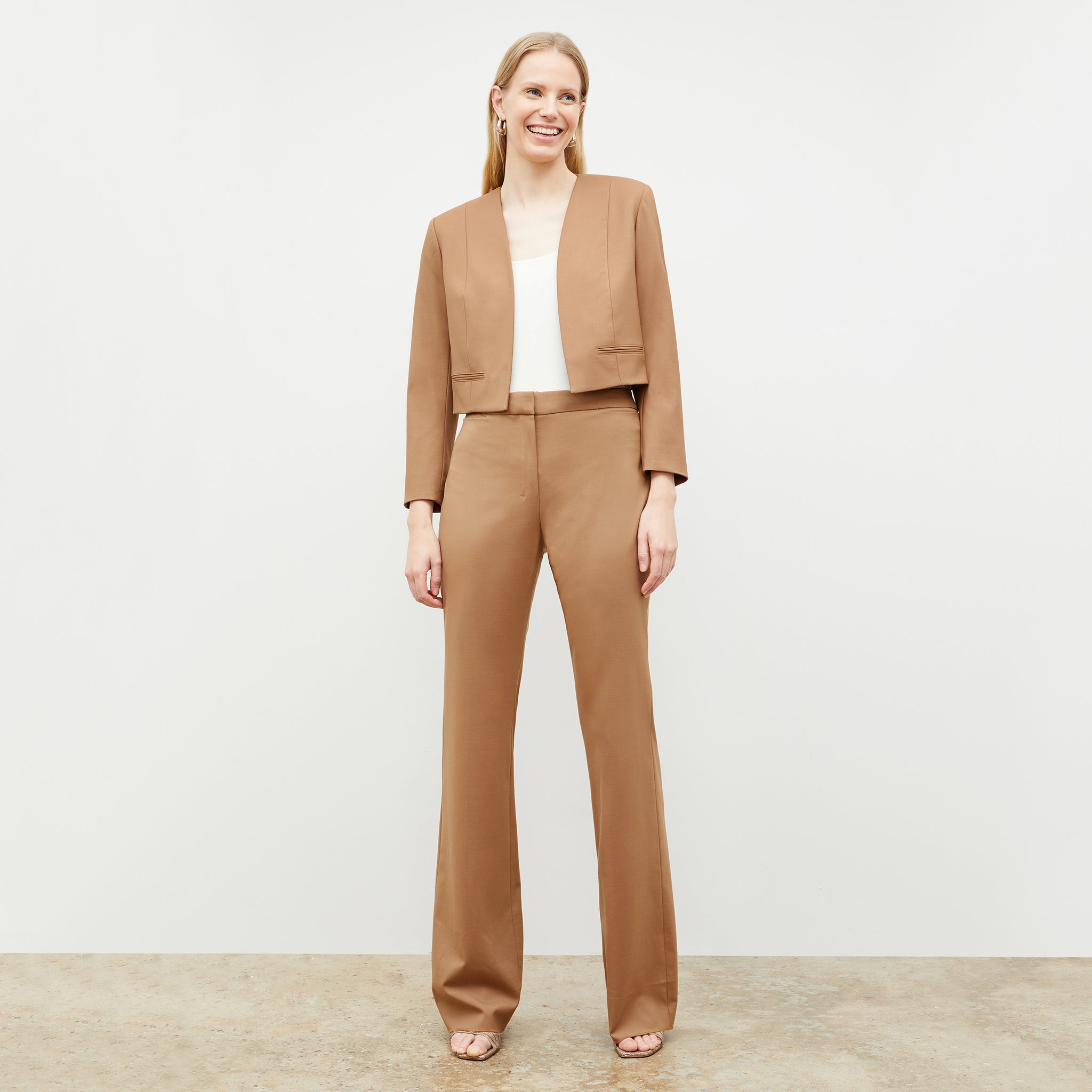 Front image of a woman standing wearing the Horton Pant-Washable Wool Twill in camel
