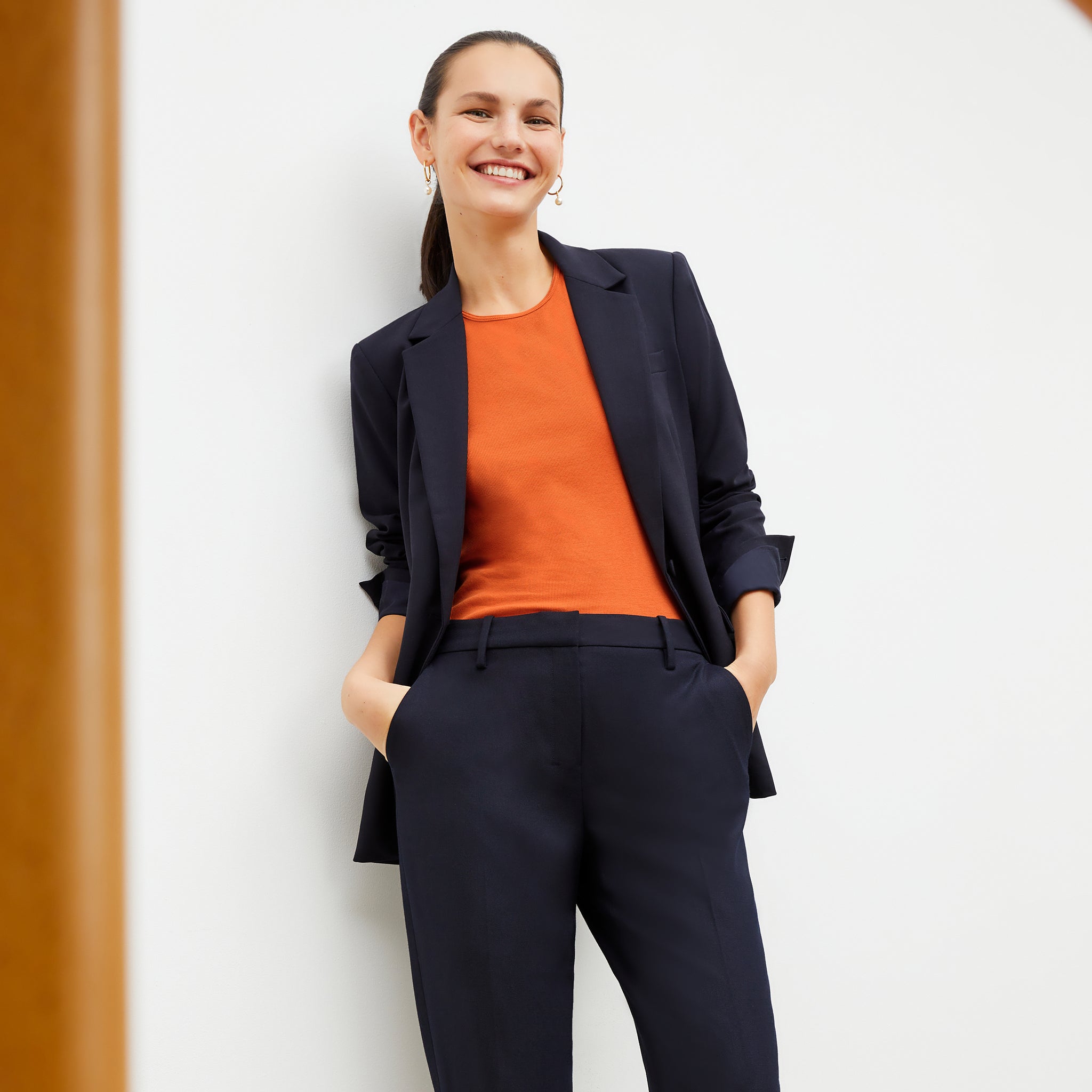 Front image of a woman wearing the paige tank in clementine