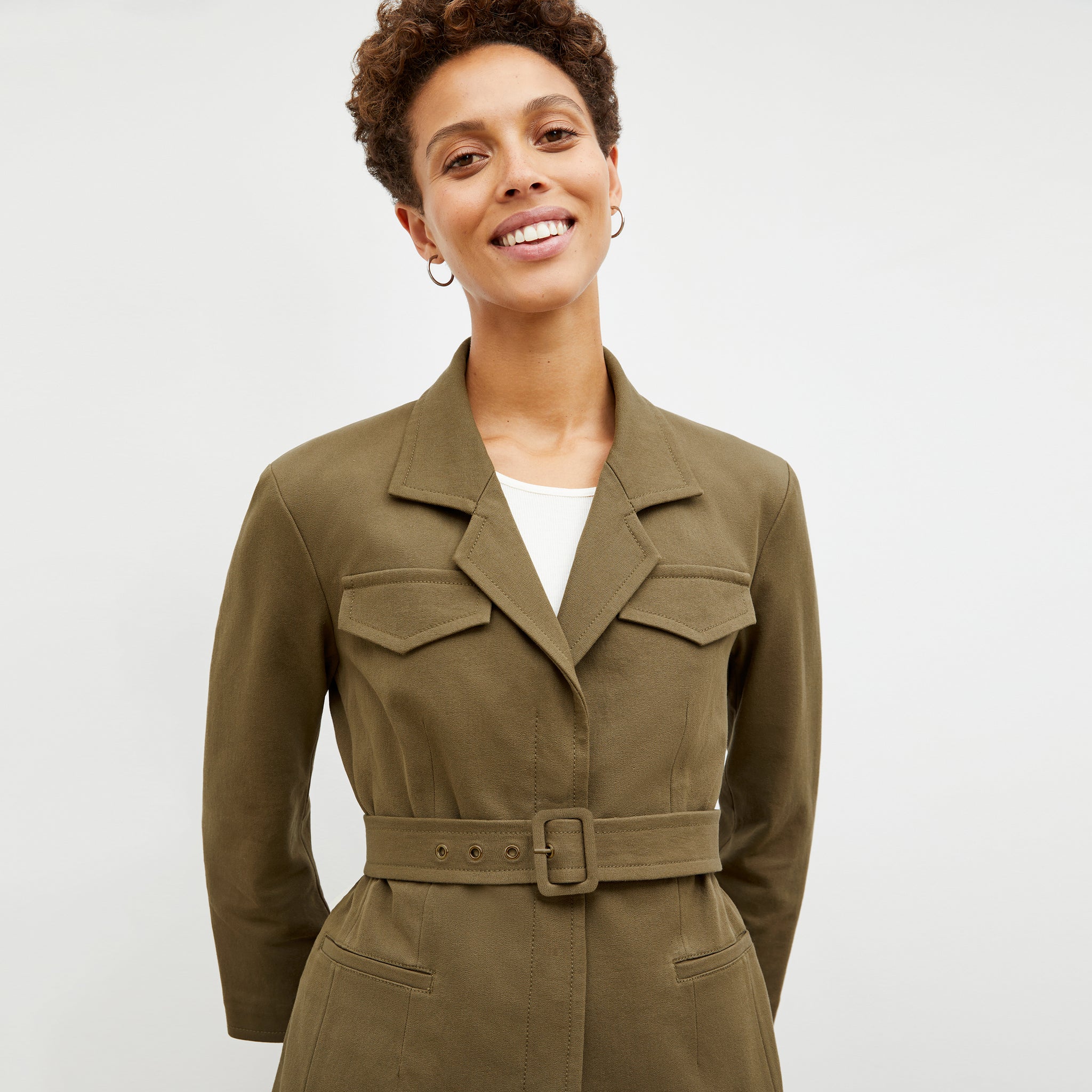 Front image of a woman in the emalis jacket in oregano