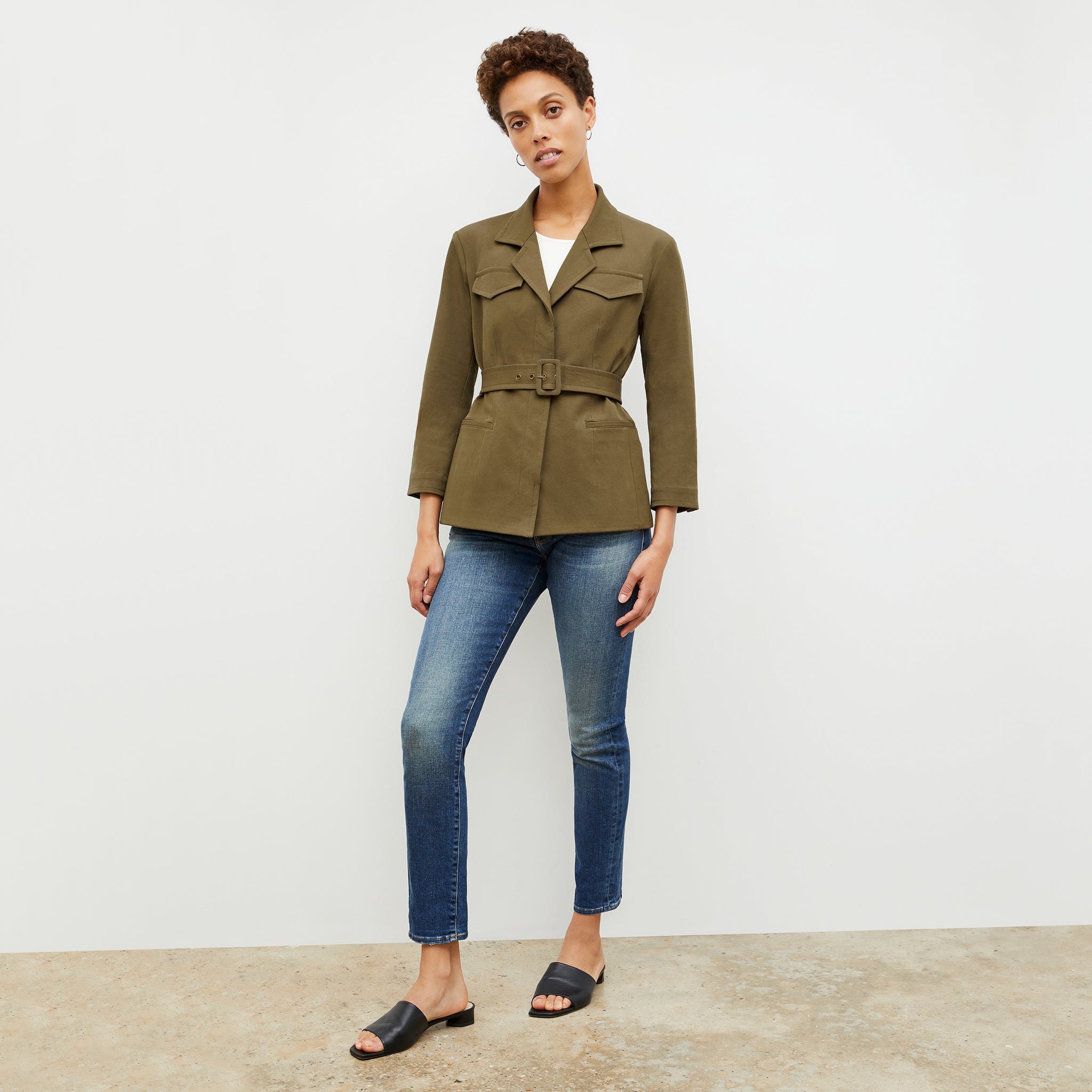 Front image of a woman standing wearing the Eileen Top in ivory