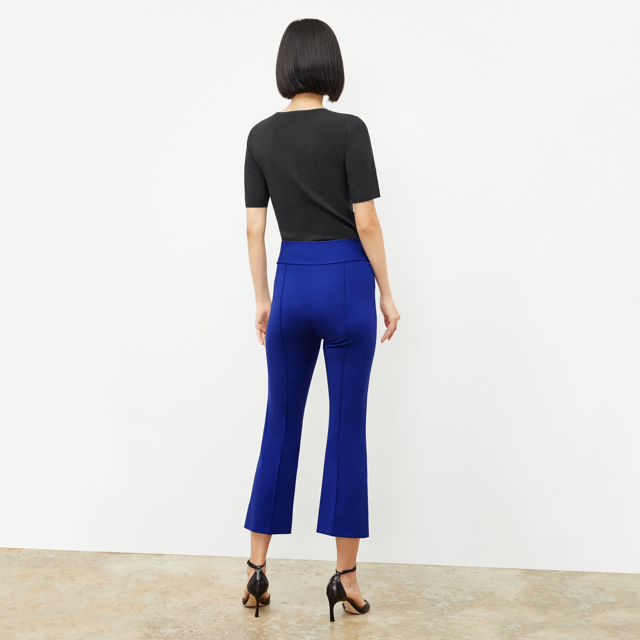 back image of a woman wearing the allyn pants in electric blue