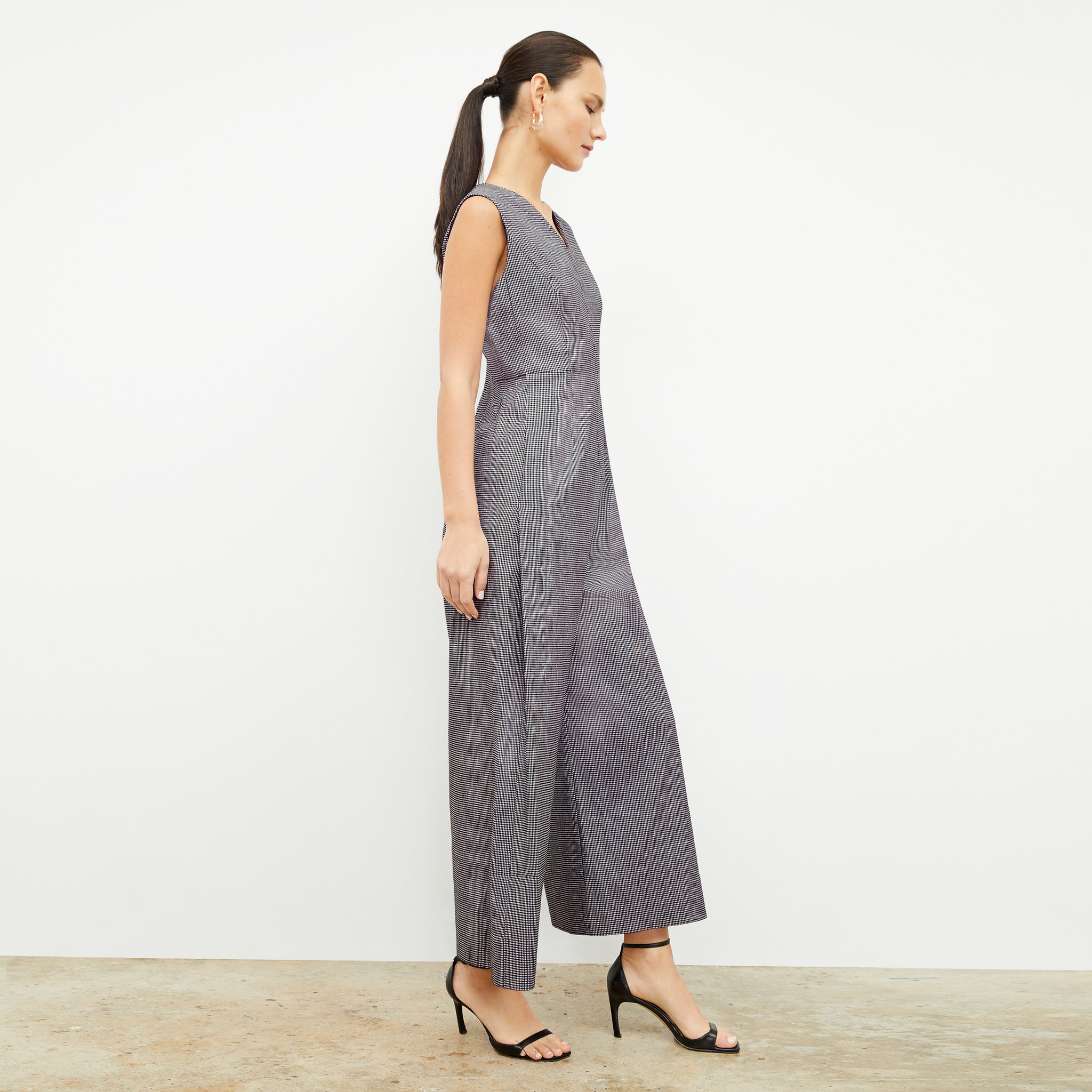 side image of a woman wearing the demi jumpsuit in gingham linen