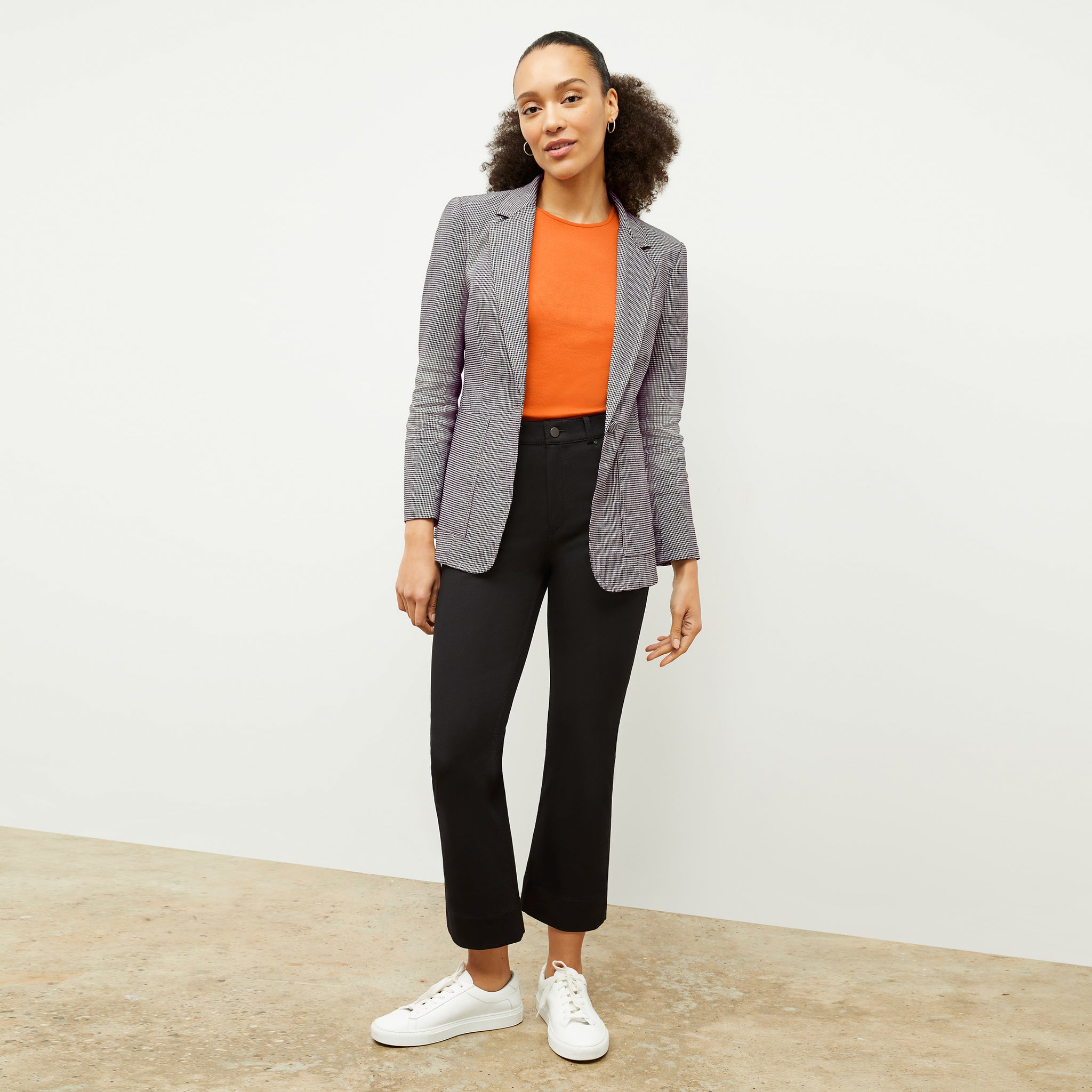 Front image of a woman wearing the paige tank in clementine