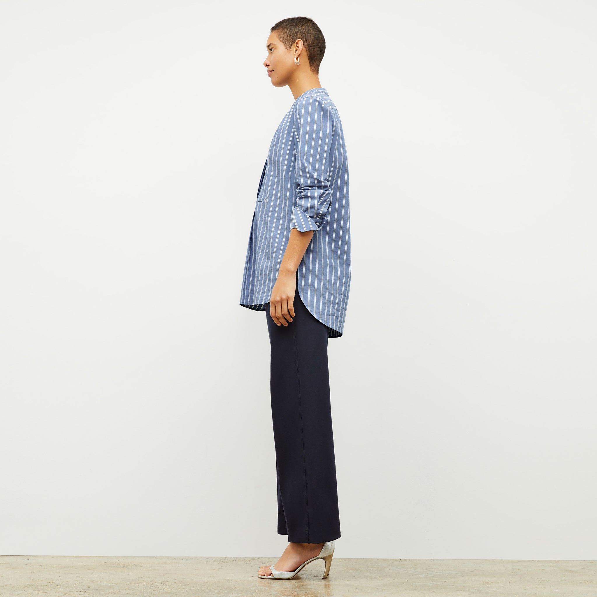 side image of a woman wearing the Nichols shirt in blue and white poplin stripe