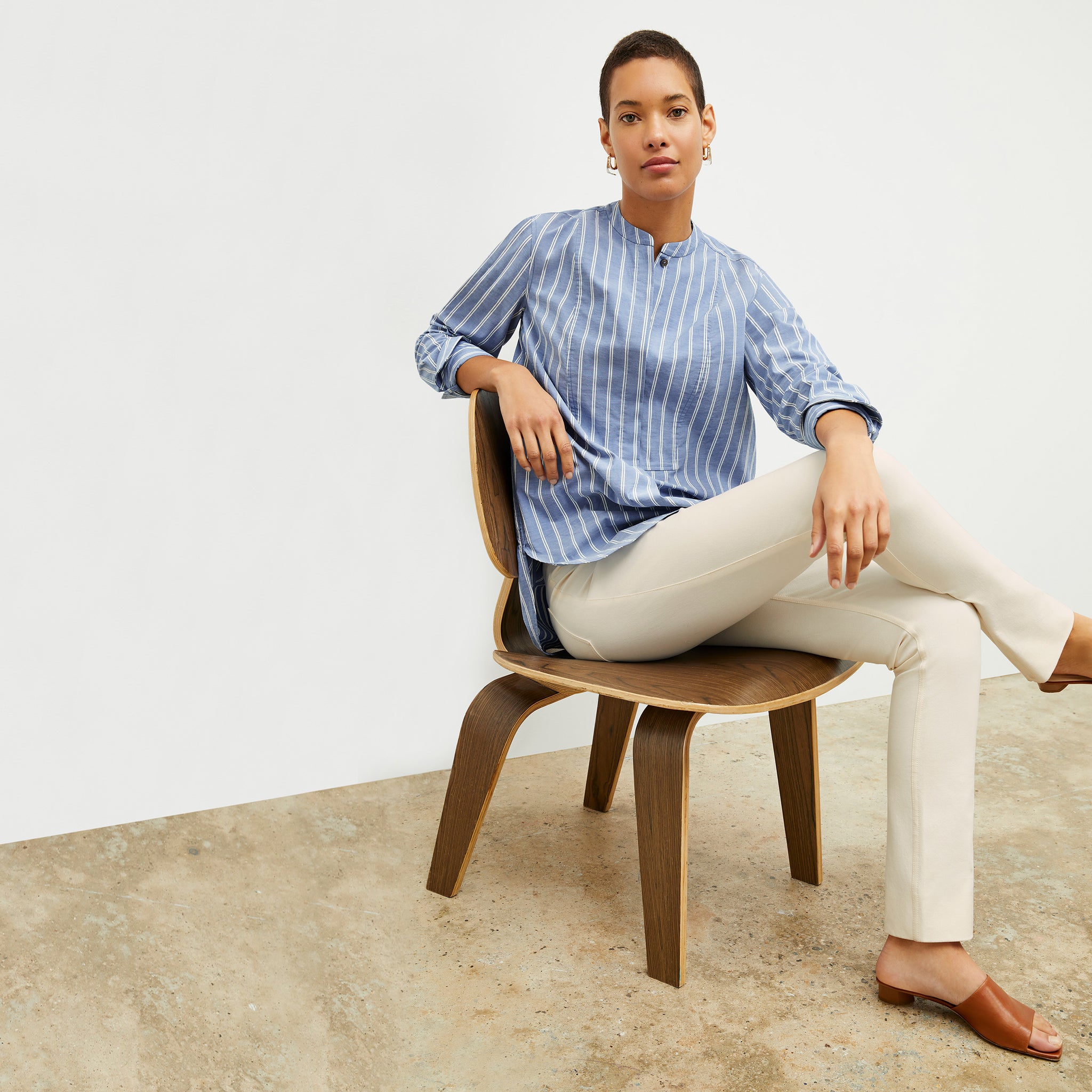 front image of a woman wearing the Nichols shirt in blue and white poplin stripe