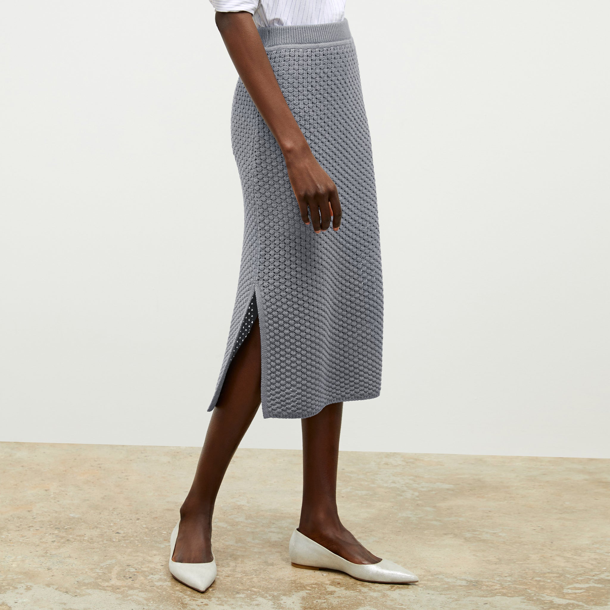 front image of a woman wearing the senga skirt in flint gray