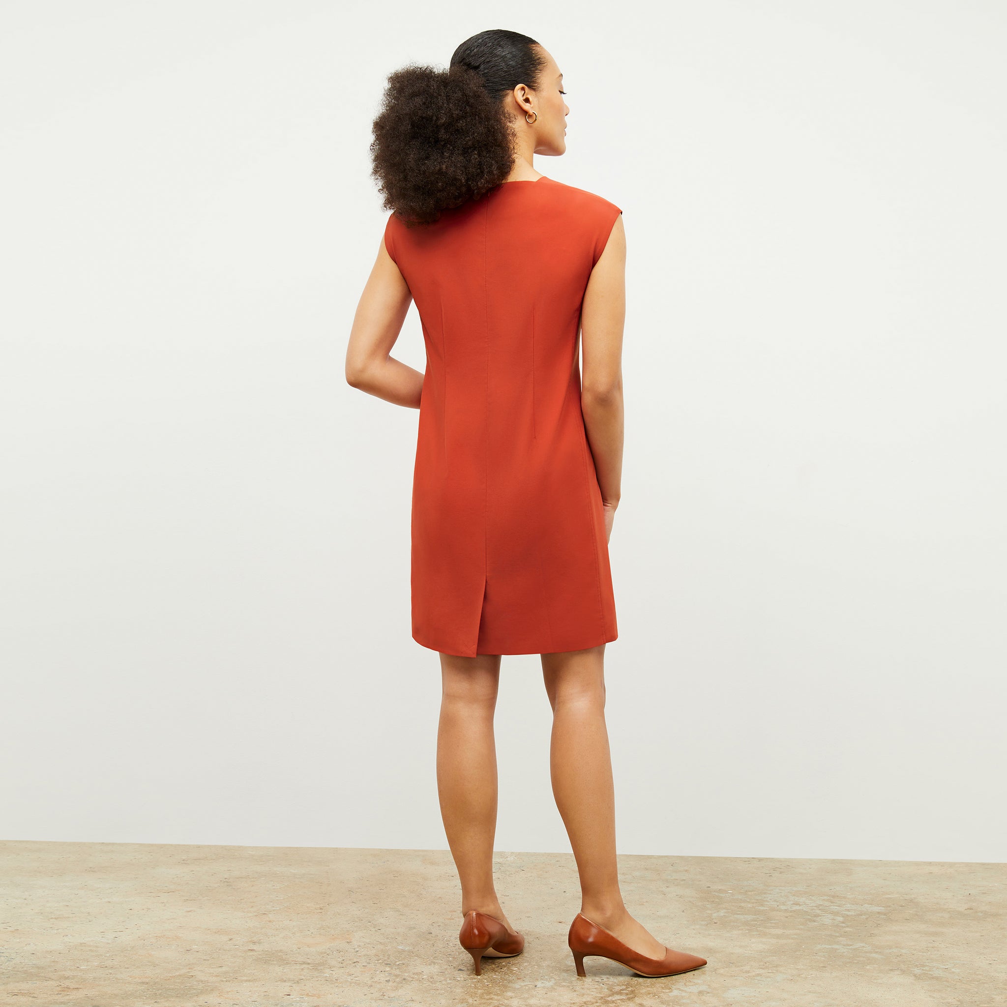 Back image of a woman wearing the Maaza Dress in Blood Orange 
