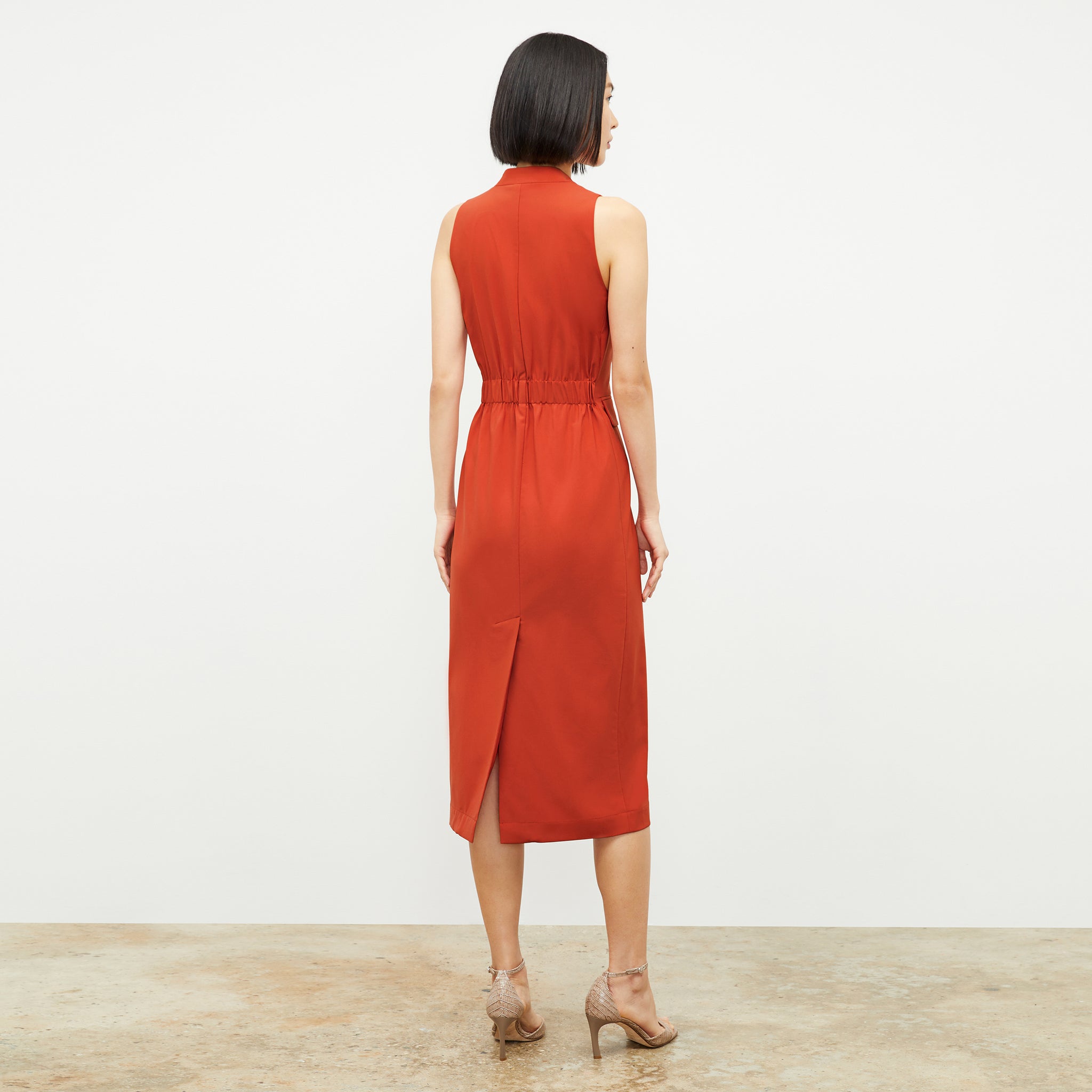 Back image of a woman wearing the Cassandra Dress in Blood Orange