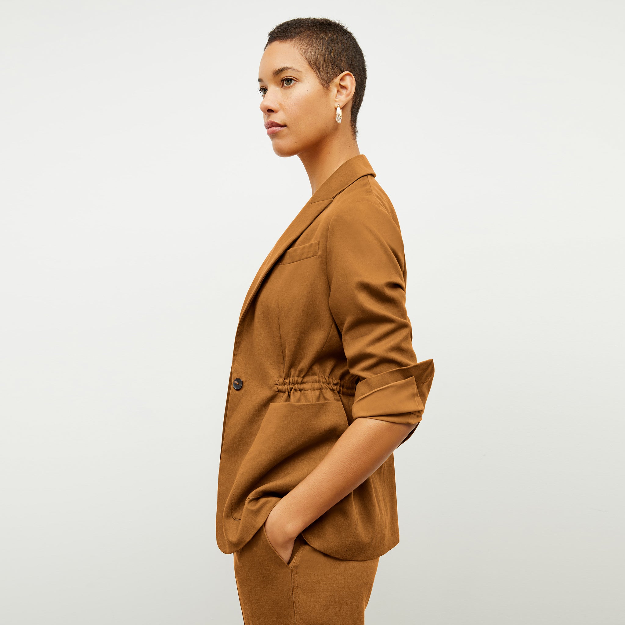 Side image of a woman wearing the Hyo jacket in acorn