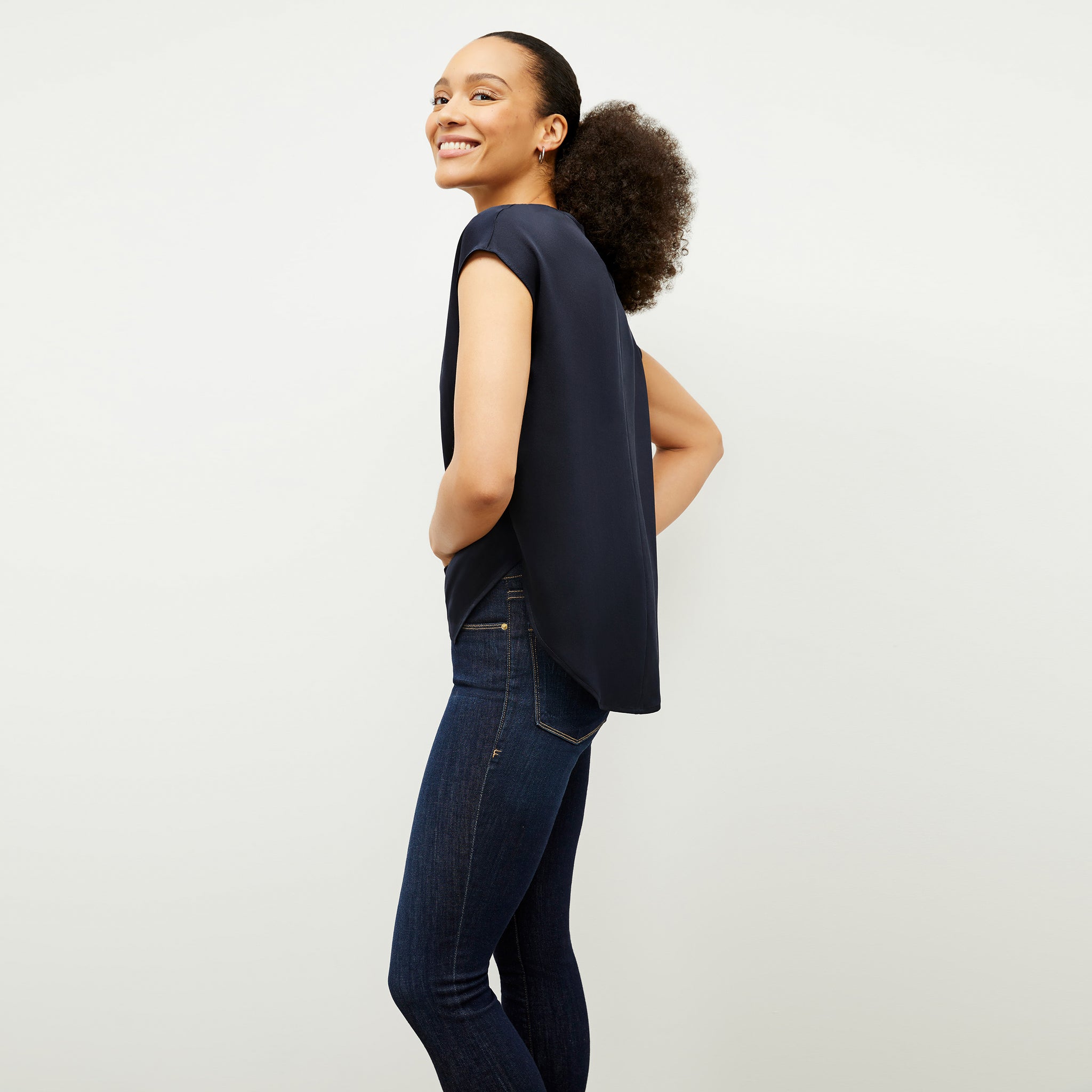 Side image of a woman wearing the Didion Top in Galaxy Blue
