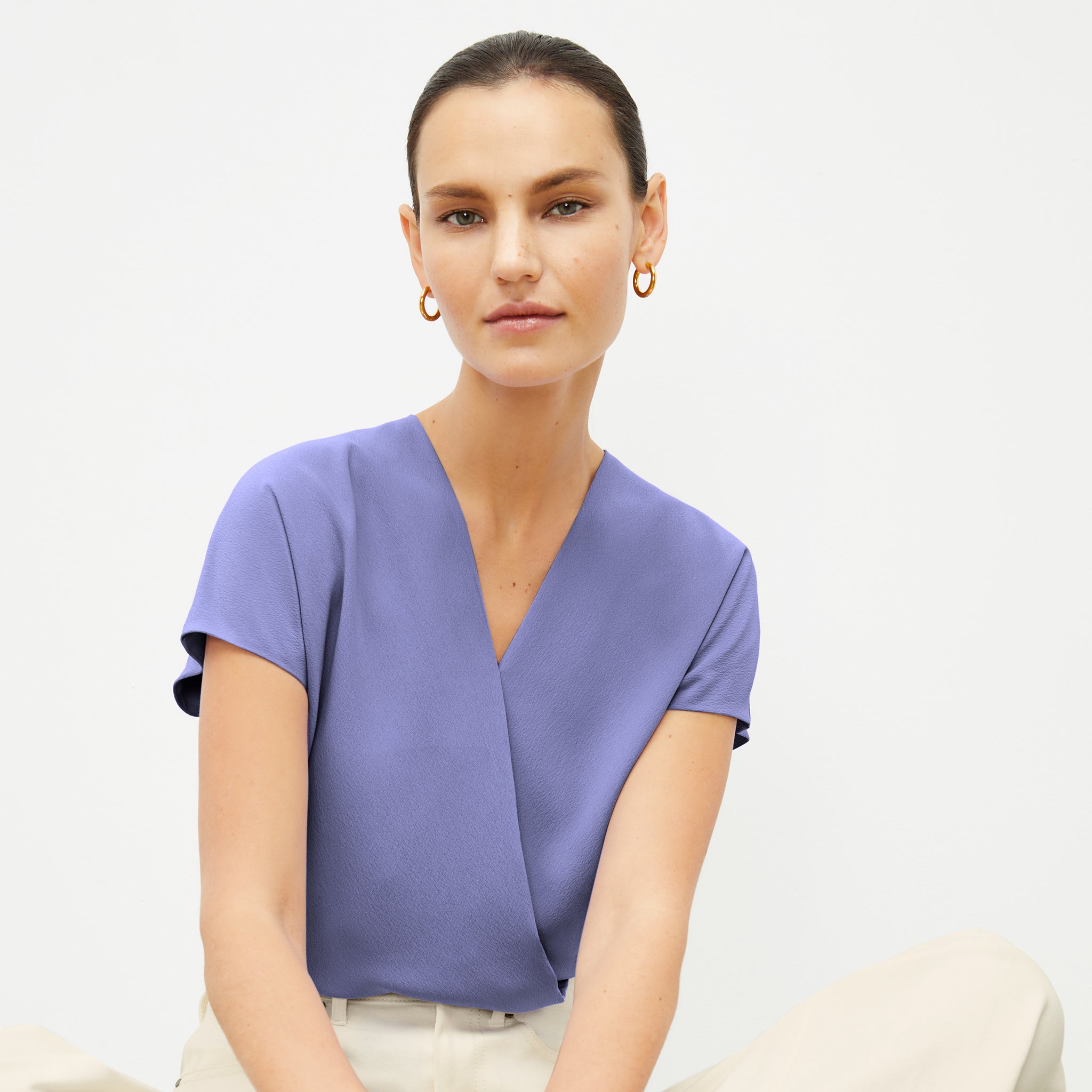 Front image of a woman wearing the Antonia Top in Iris 