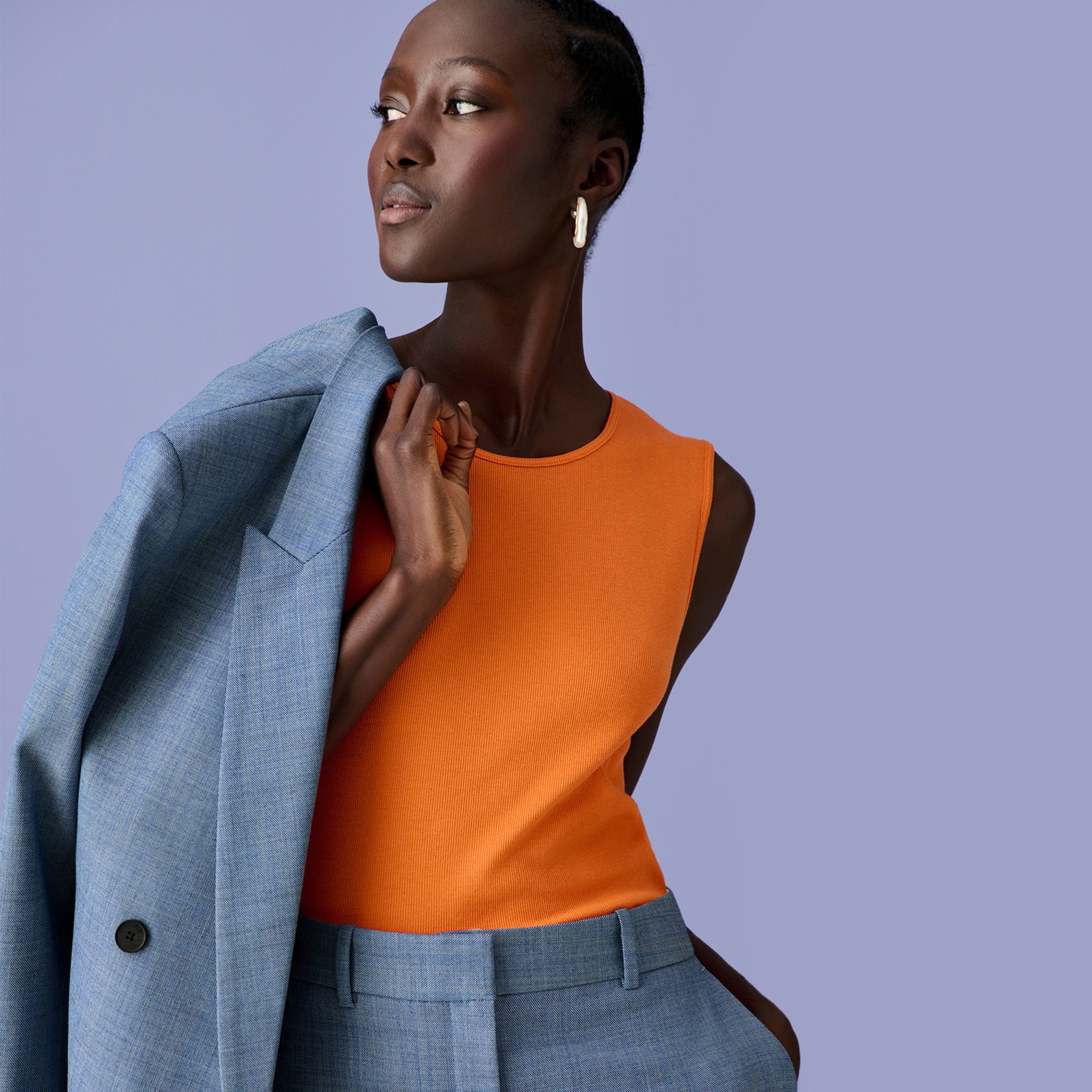 Front image of a woman wearing the paige tank in clementine