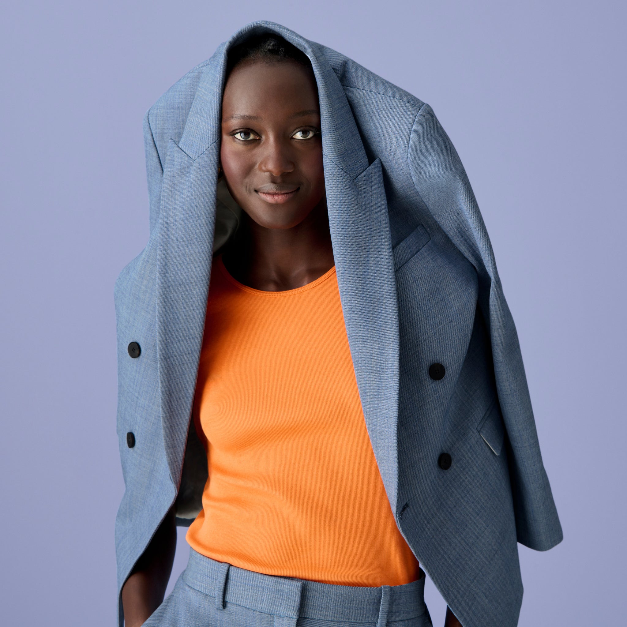 Front image of a woman wearing the paige tank in clementine