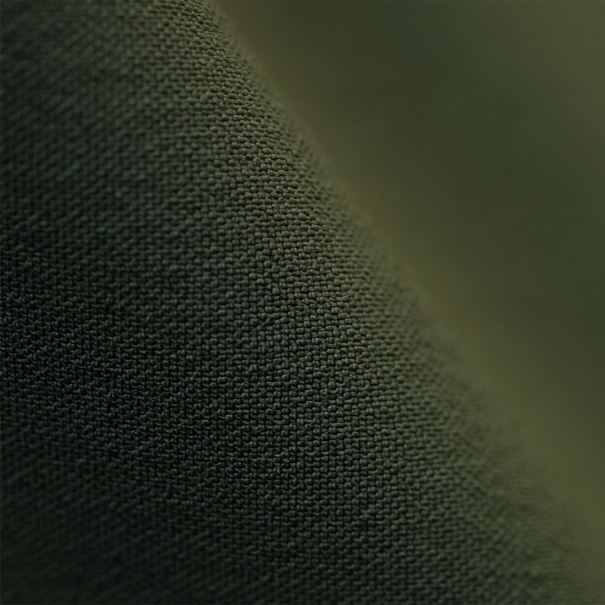 Close up image of origami tech fabric in olive