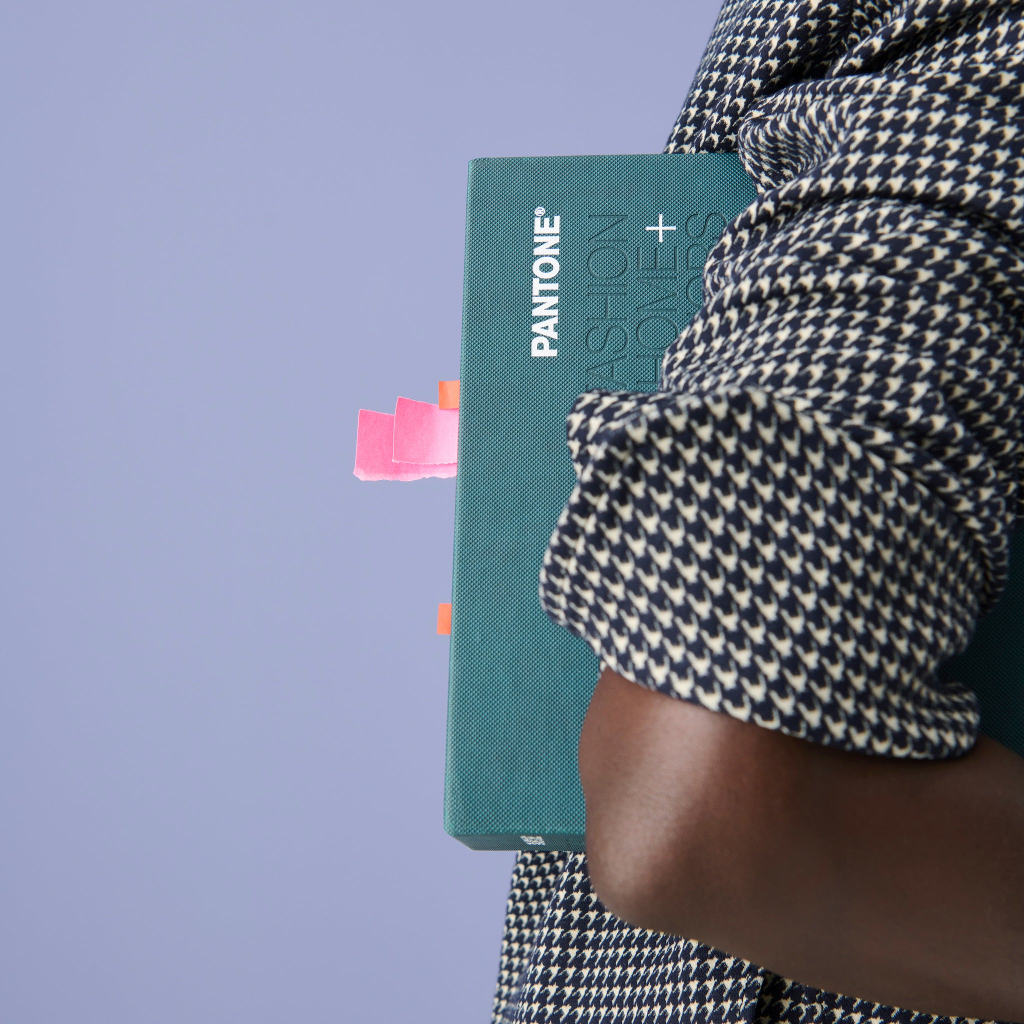 Image of a woman in the Tully Top in Houndstooth holding a pantone book under her arm