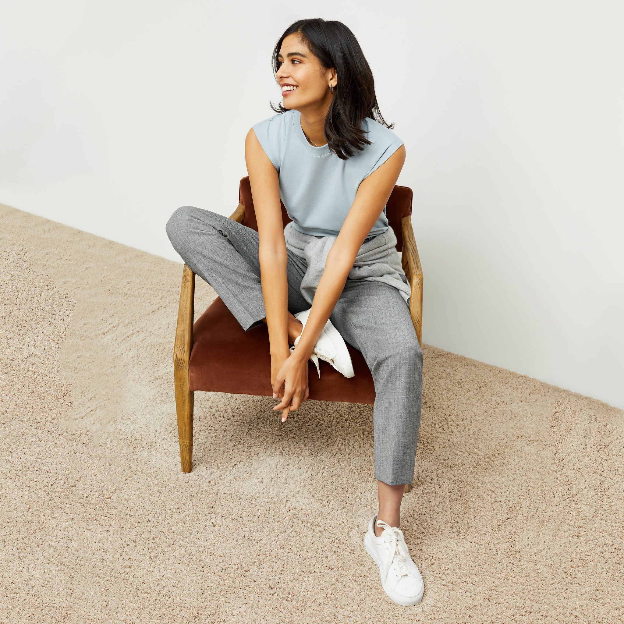 Front image of a woman standing wearing the Alina T-Shirt—Compact Cotton in Sky Blue
