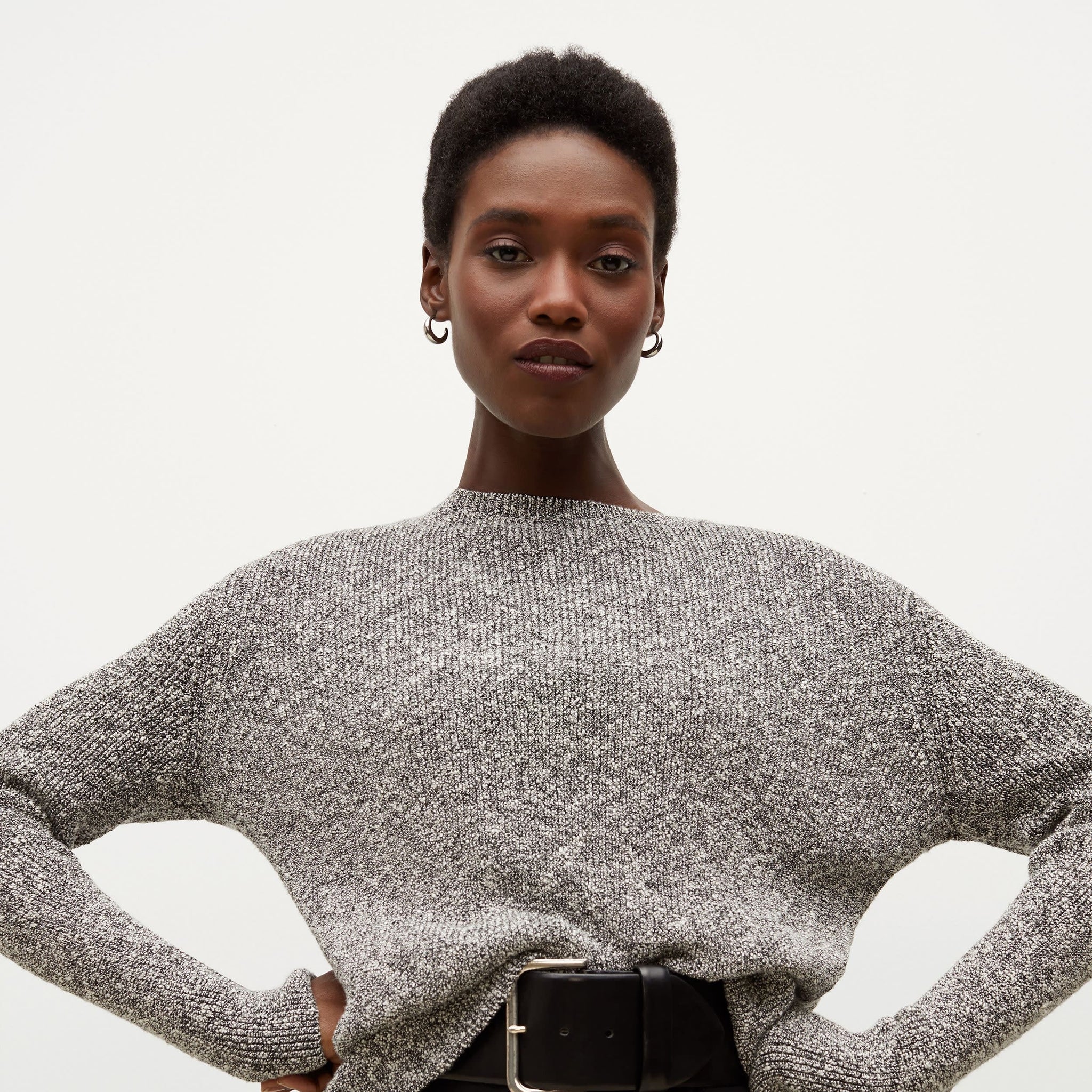 Detail image of a woman standing wearing the Butler Sweater—Knit Boucle in Black / White