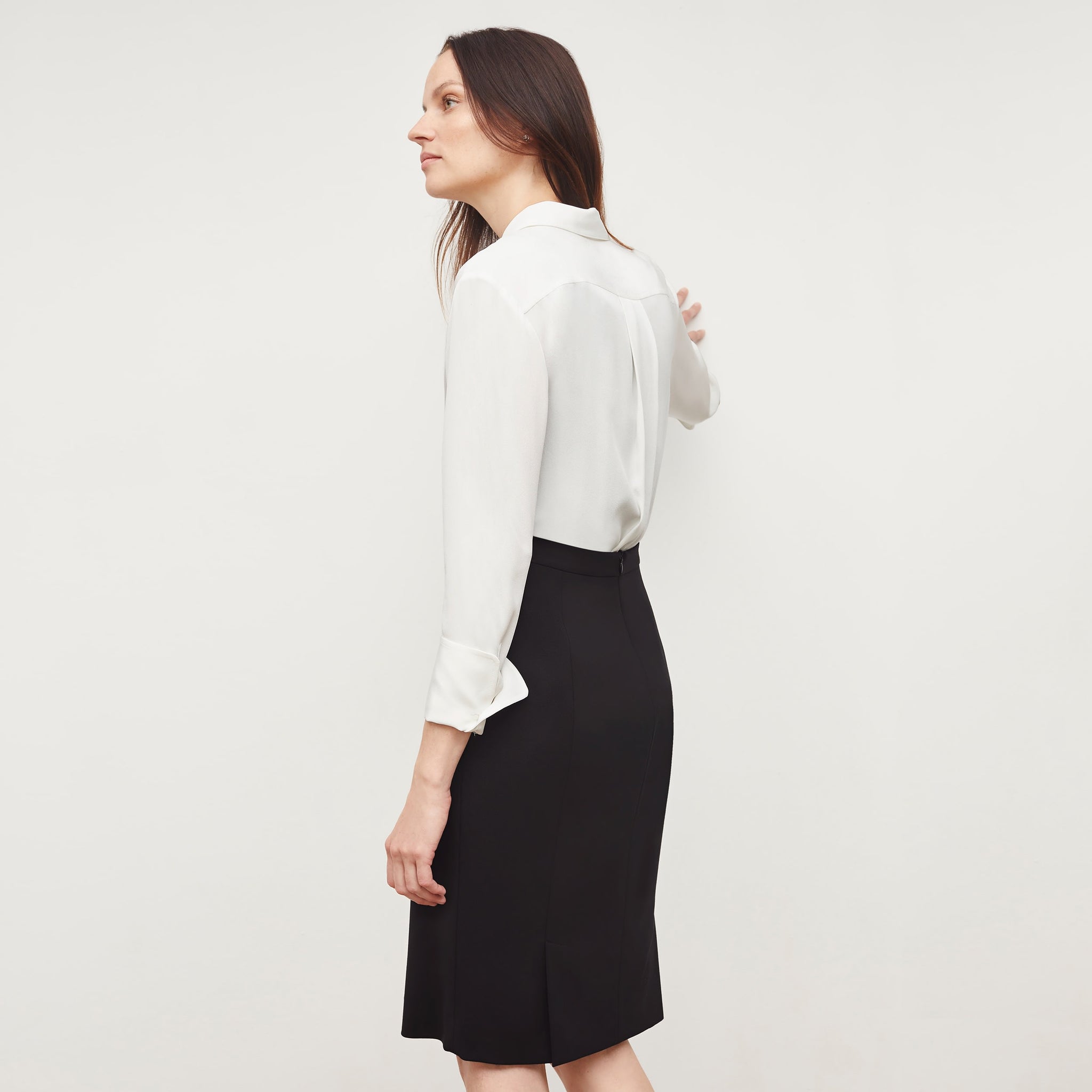 Back image of a woman standing wearing the Cobble Hill Skirt—Washable Wool Twill in Black