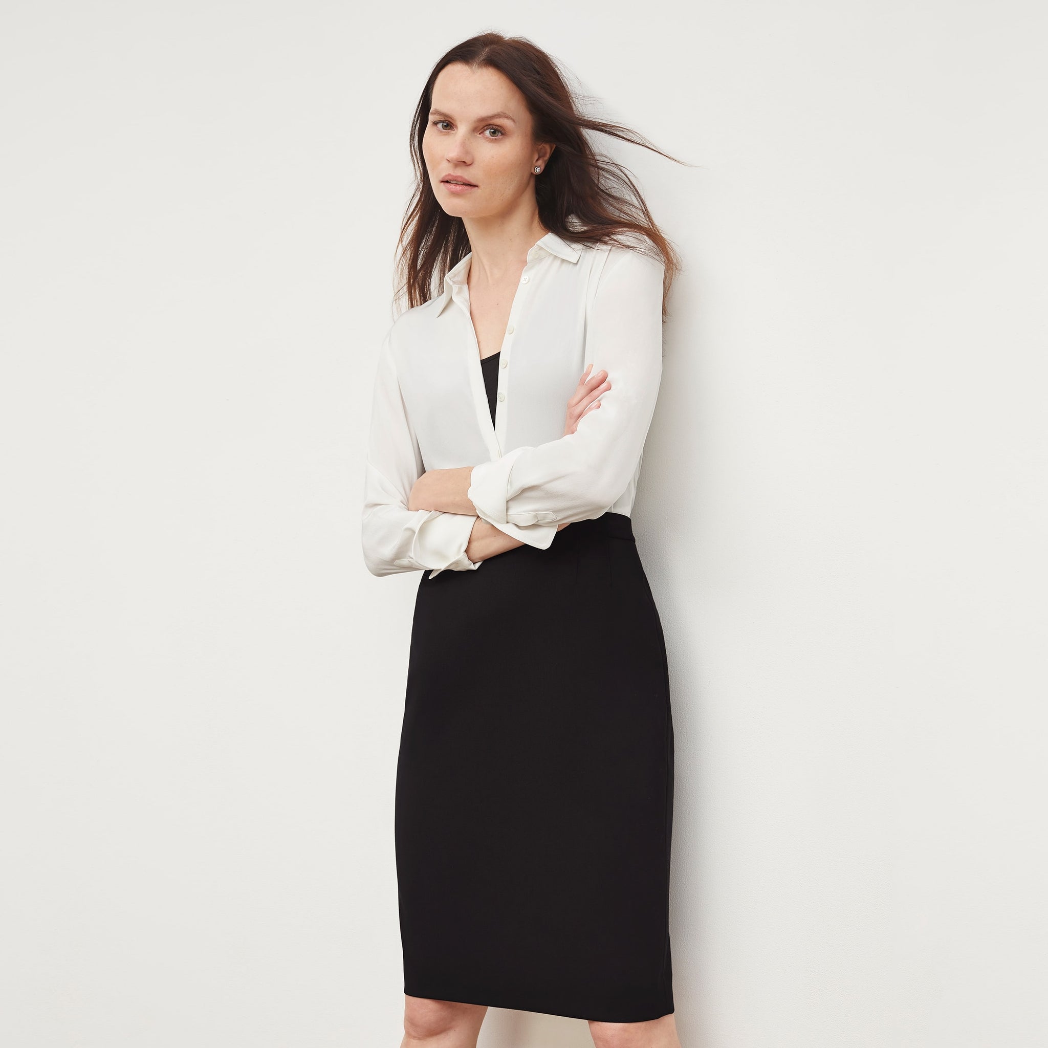 Front image of a woman standing wearing the Cobble Hill Skirt—Washable Wool Twill in Black