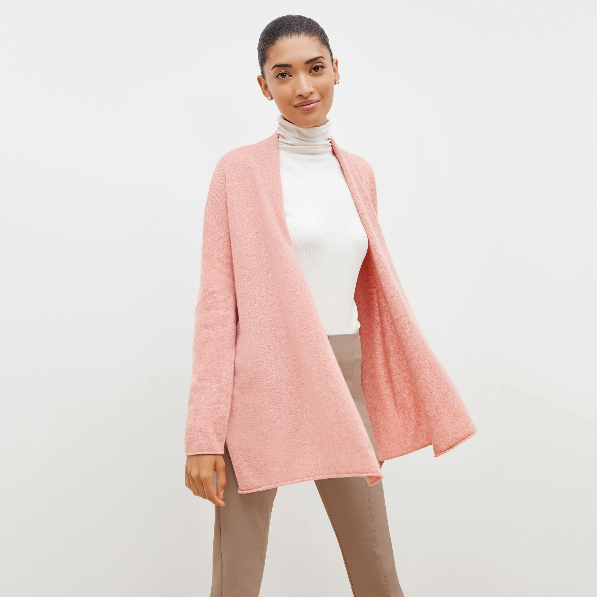 Front image of a woman standing wearing the Daphne sweater in Rose Heather