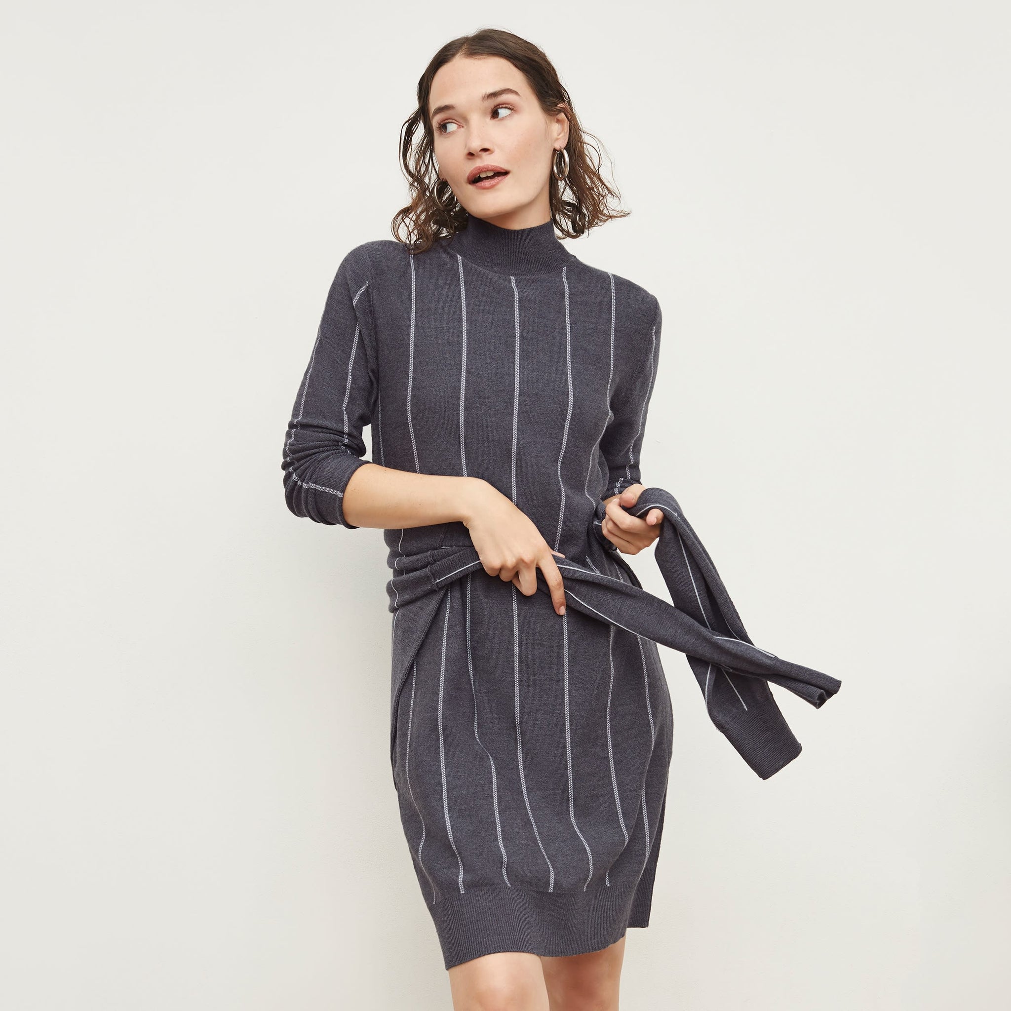 Front image of a woman standing wearing the Effy Dress—Braided Stripe in Charcoal / Ivory