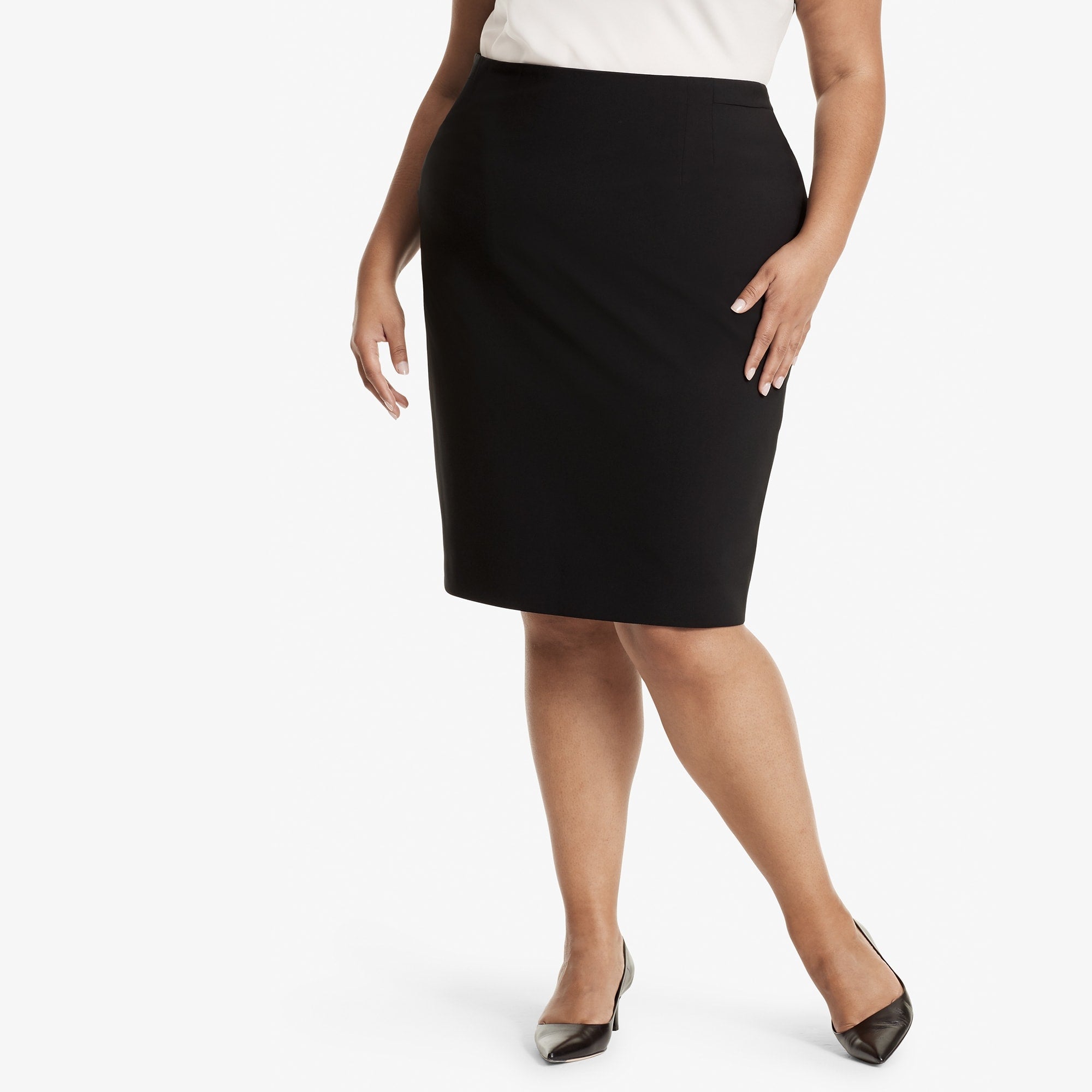 Front image of a woman standing wearing the Cobble hill skirt in Black