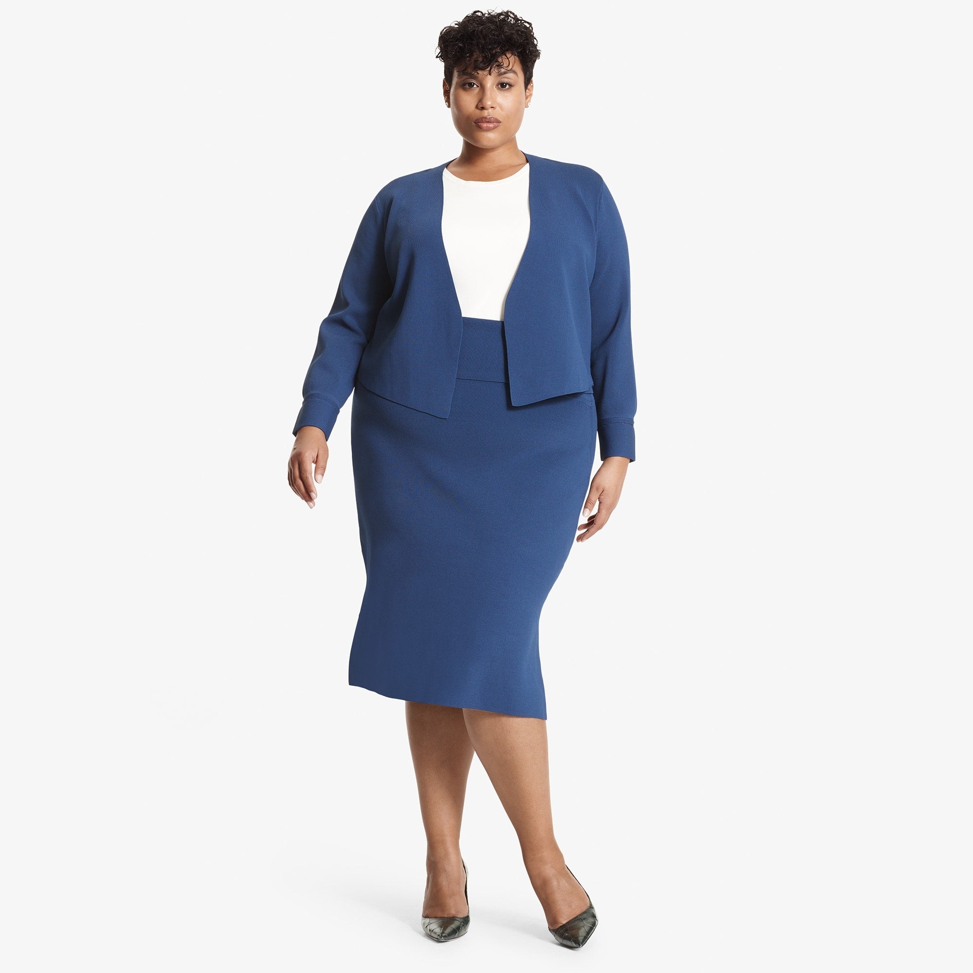 Front image of a woman standing wearing the Harlem skirt in Regent blue