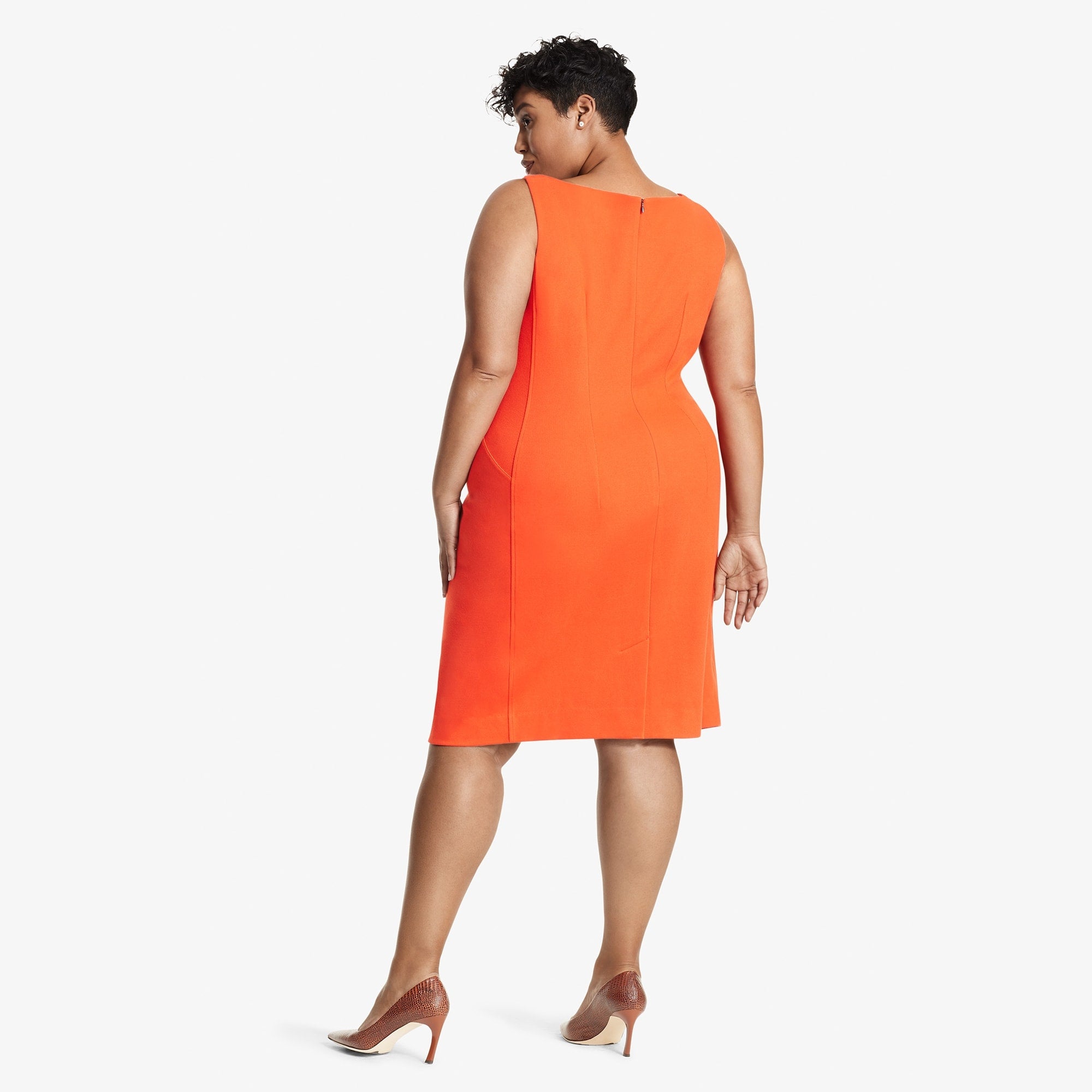 Back image of a woman standing wearing the Lydia dress textured ponte in Tangerine