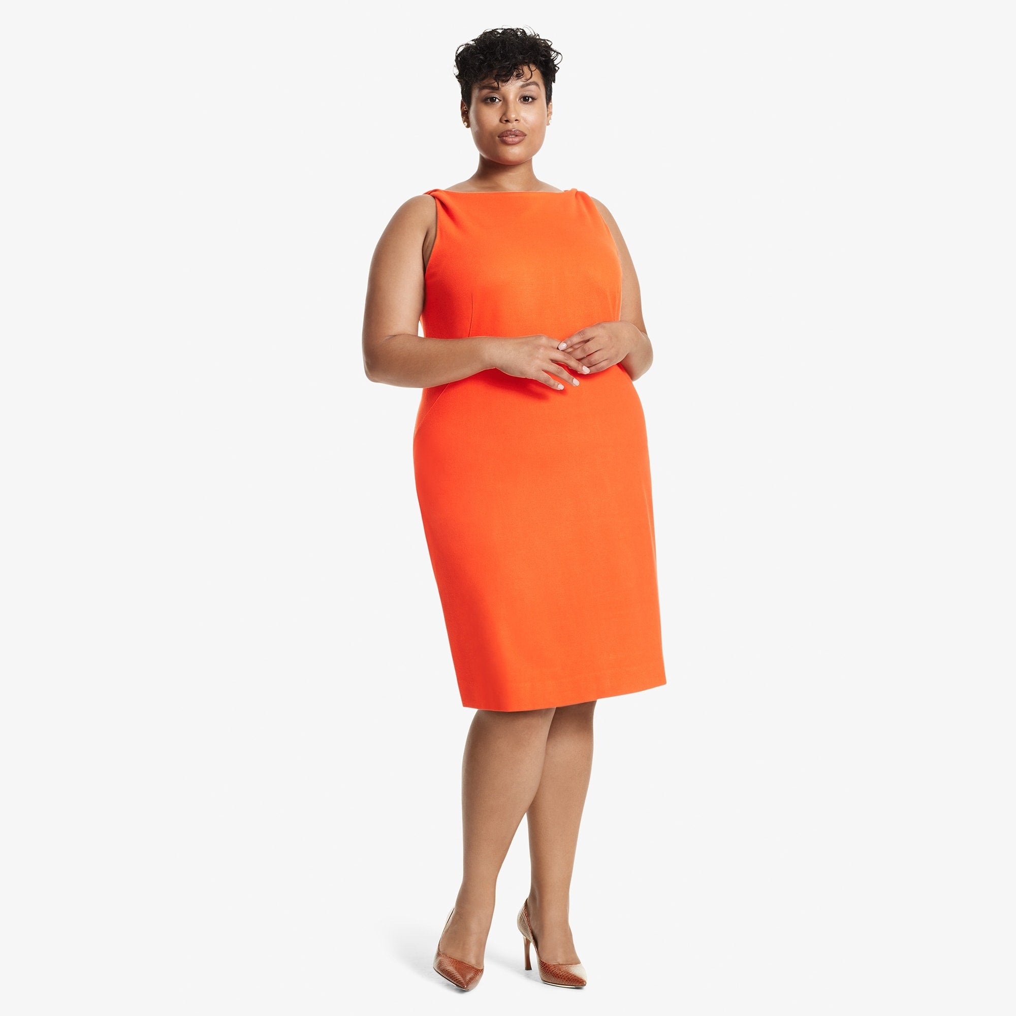 Front image of a woman standing wearing the Lydia dress textured ponte in Tangerine 