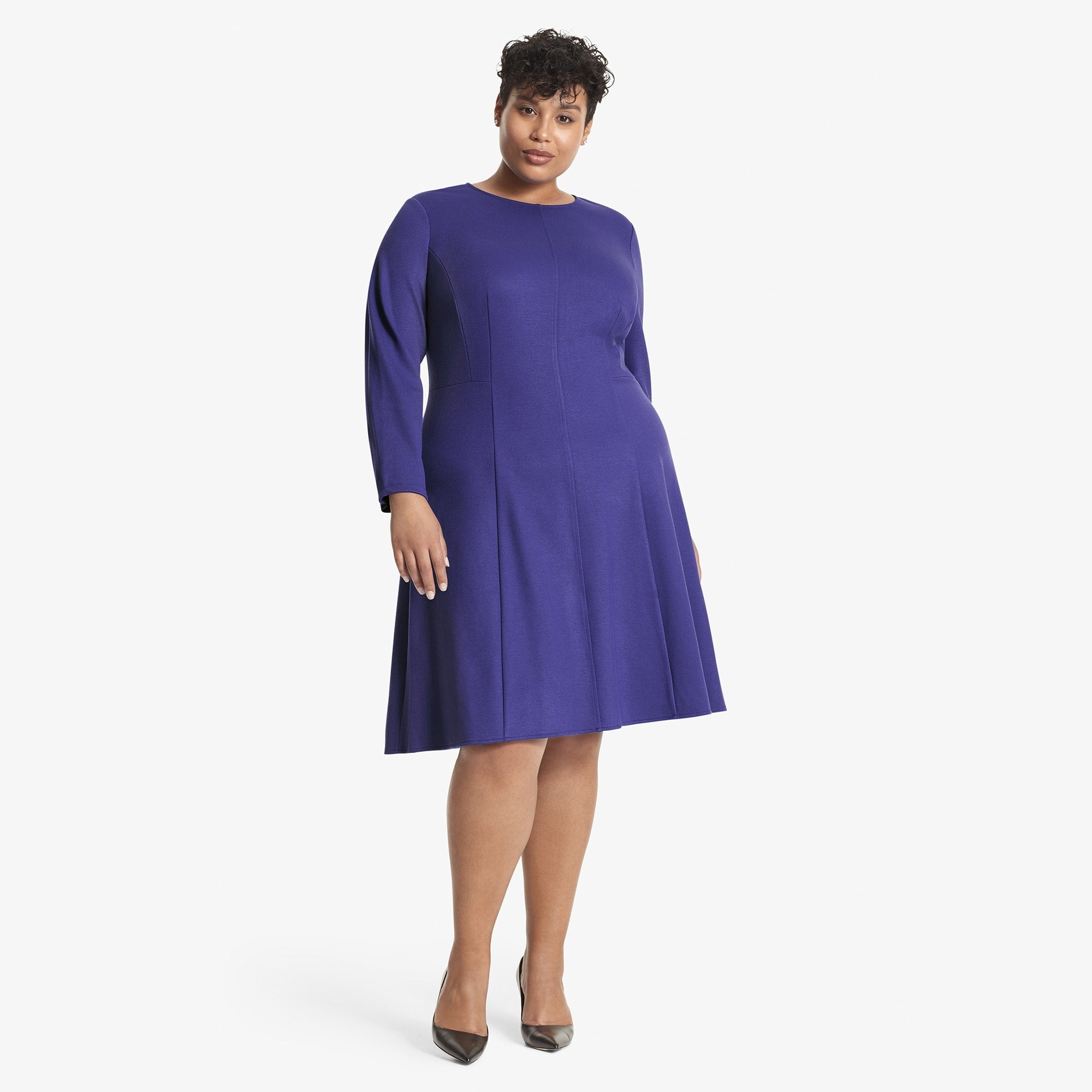 Front image of a woman standing wearing the Ellis dress textured ponte in Violet 