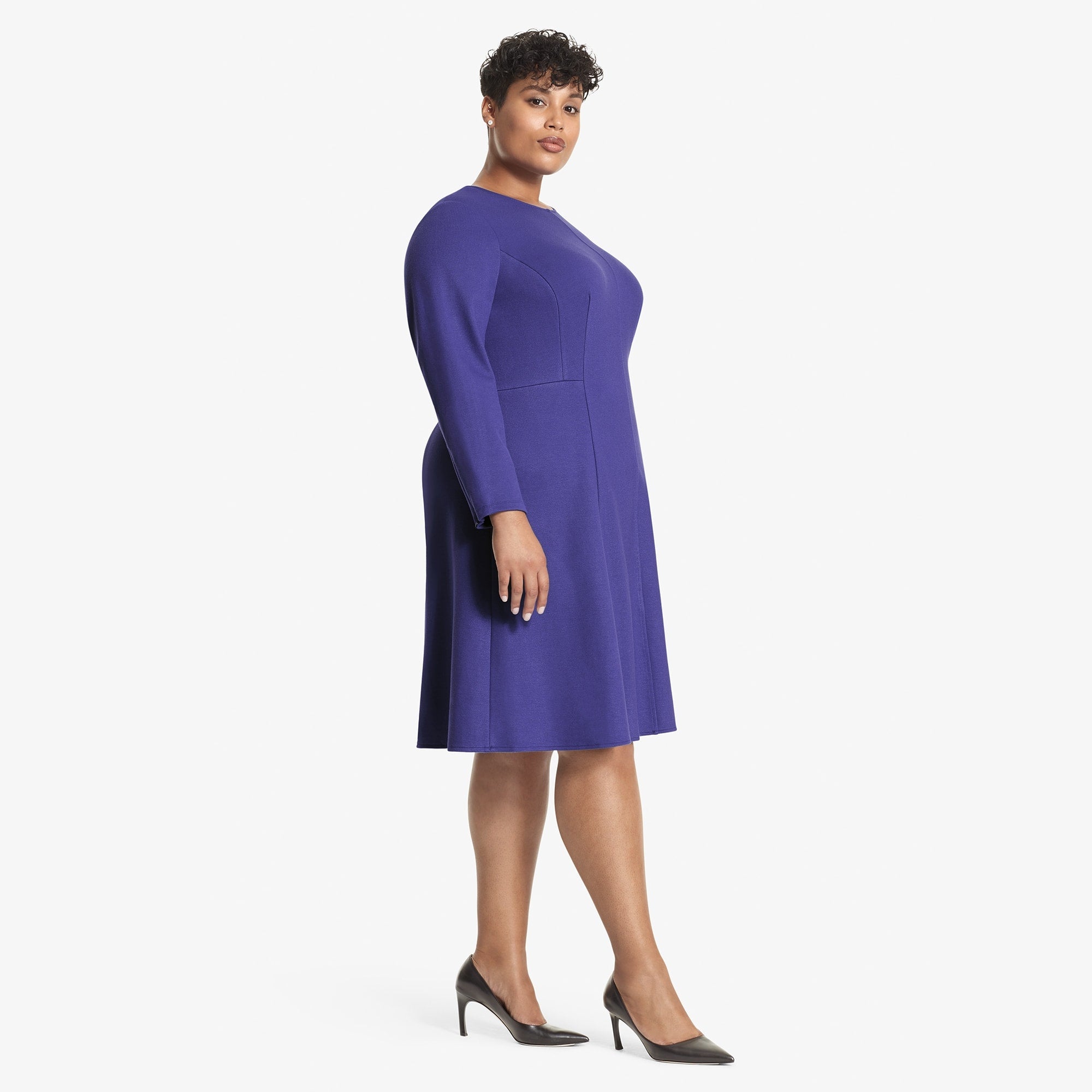 Side image of a woman standing wearing the Ellis dress textured ponte in Violet