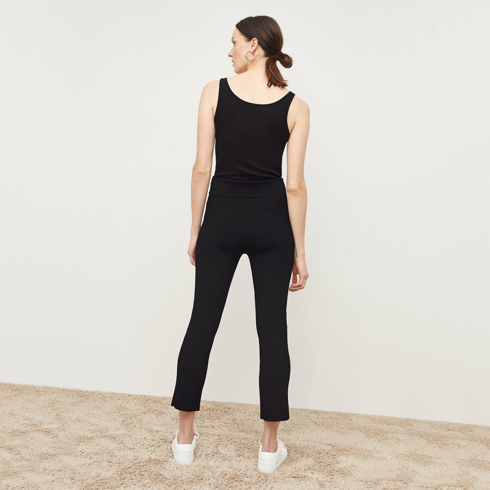 Back image of a woman standing wearing the Finley Legging—Ribbed Jardigan Knit in Black