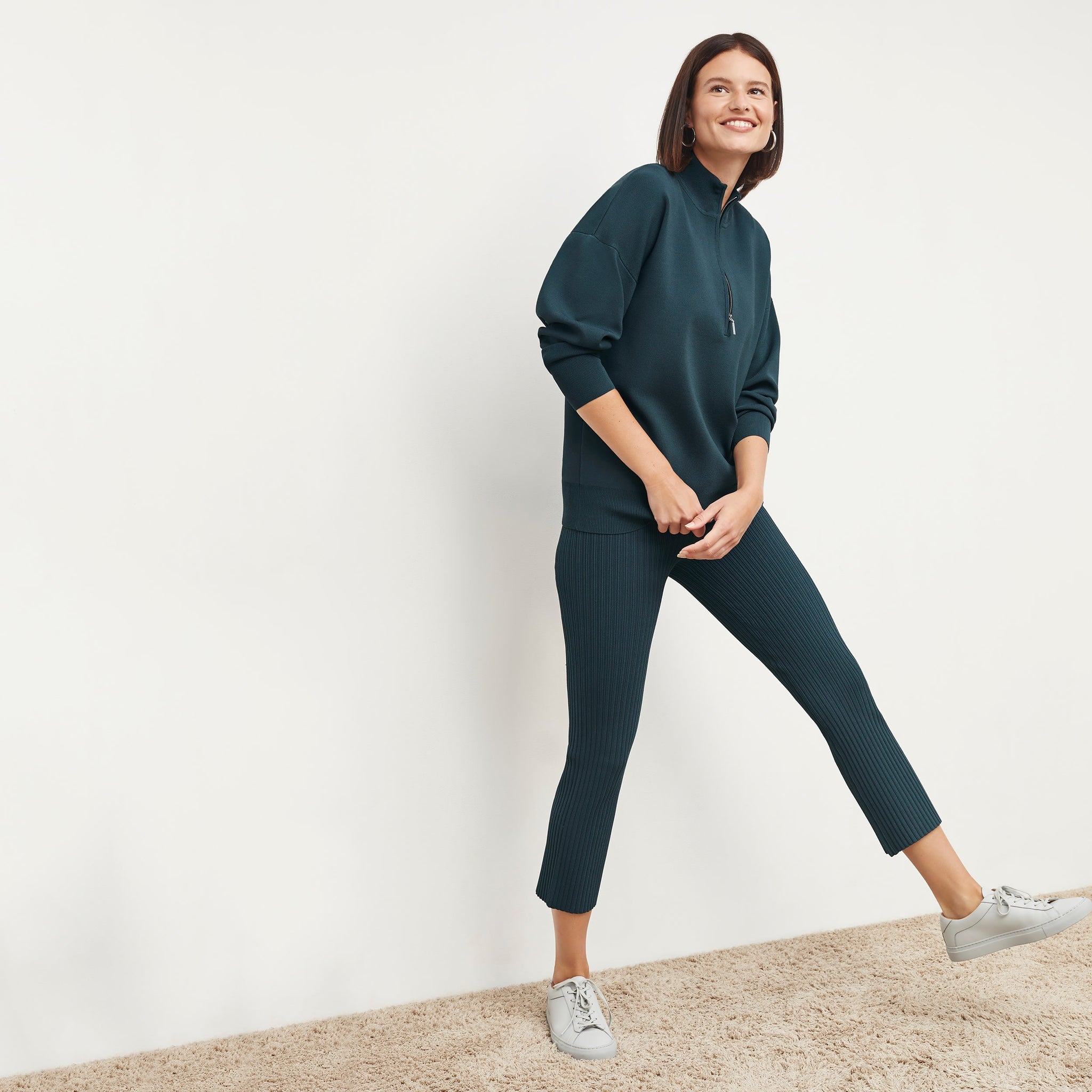Front image of a woman standing wearing the Finley Legging—Ribbed Jardigan Knit in Deep Sea 