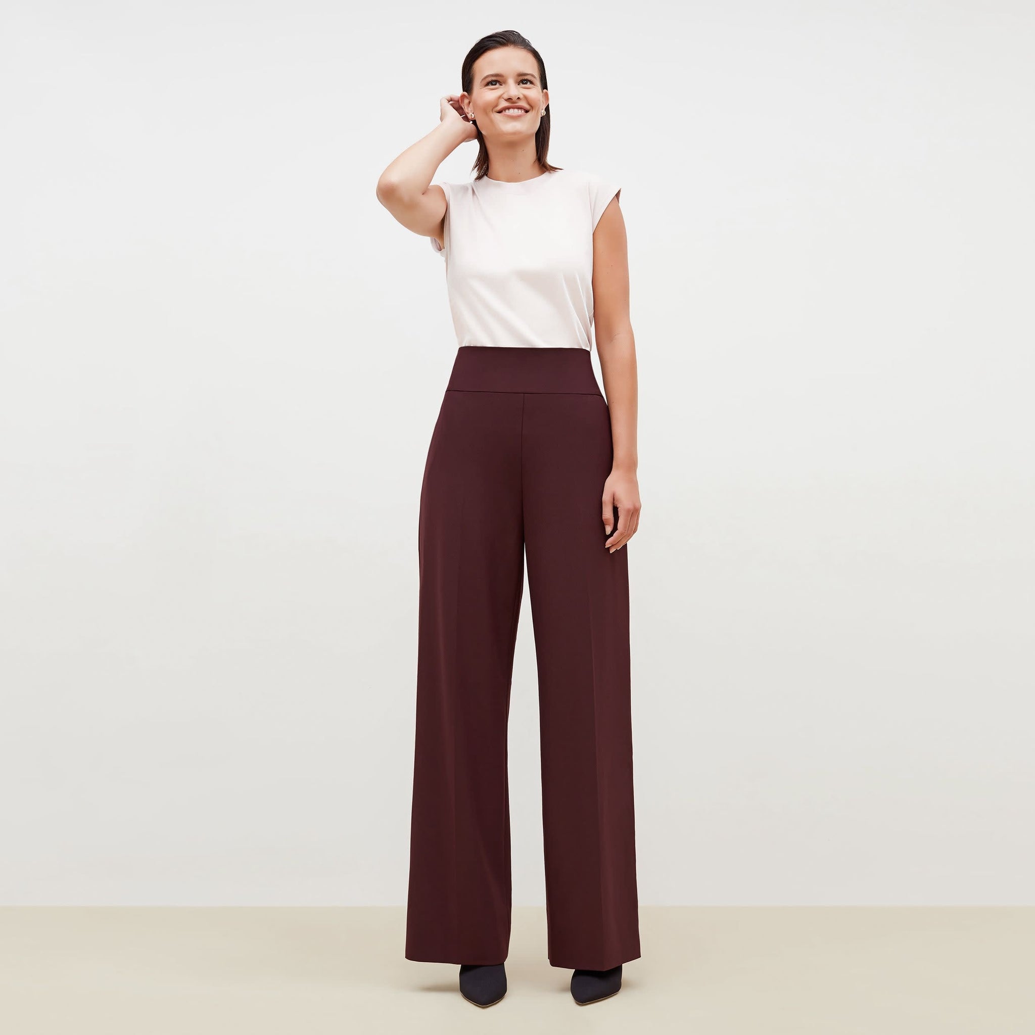 Front image of a woman standing wearing the Hadley Pant-Sharkskin in garnet 