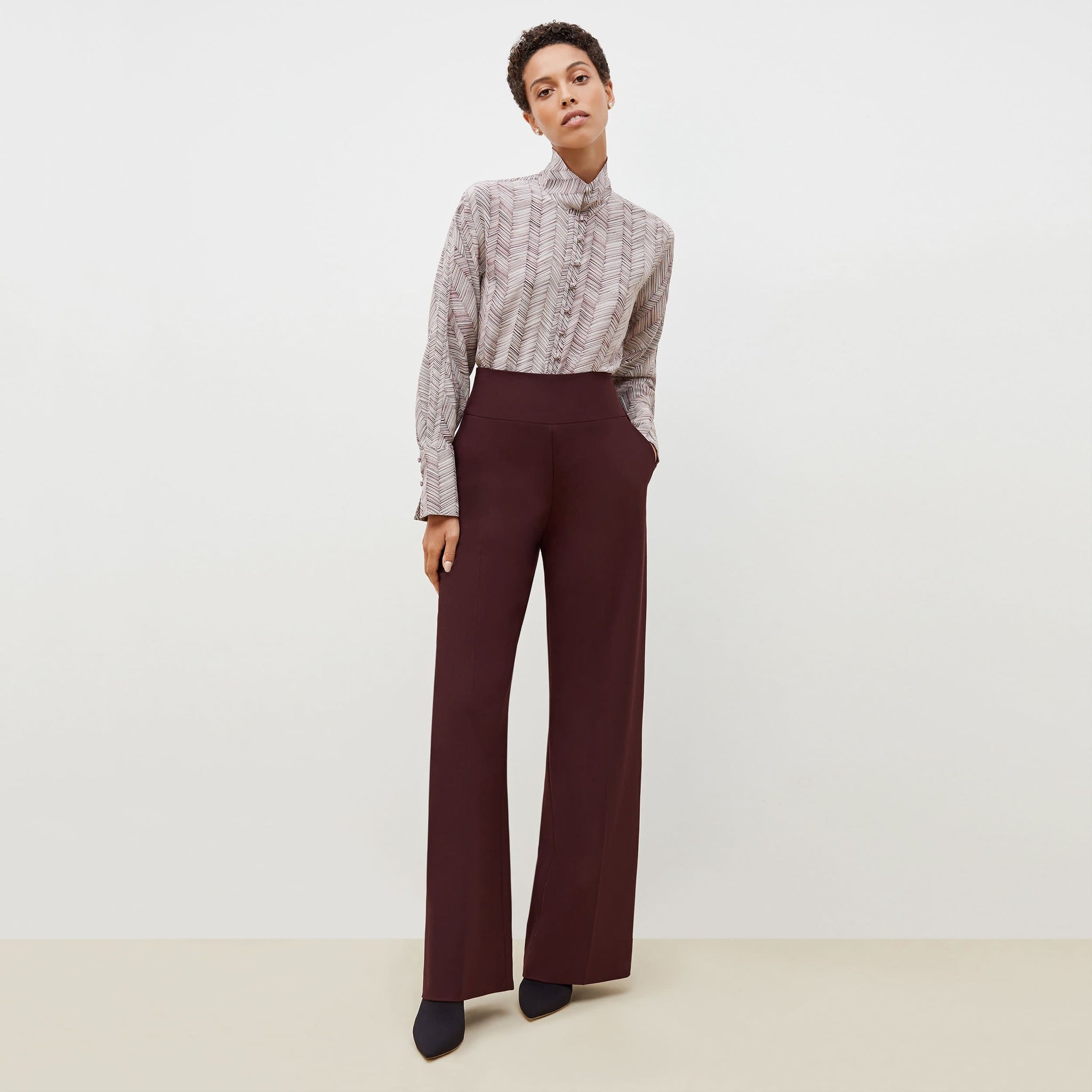 Front image of a woman standing wearing the Hadley Pant-Sharkskin in garnet