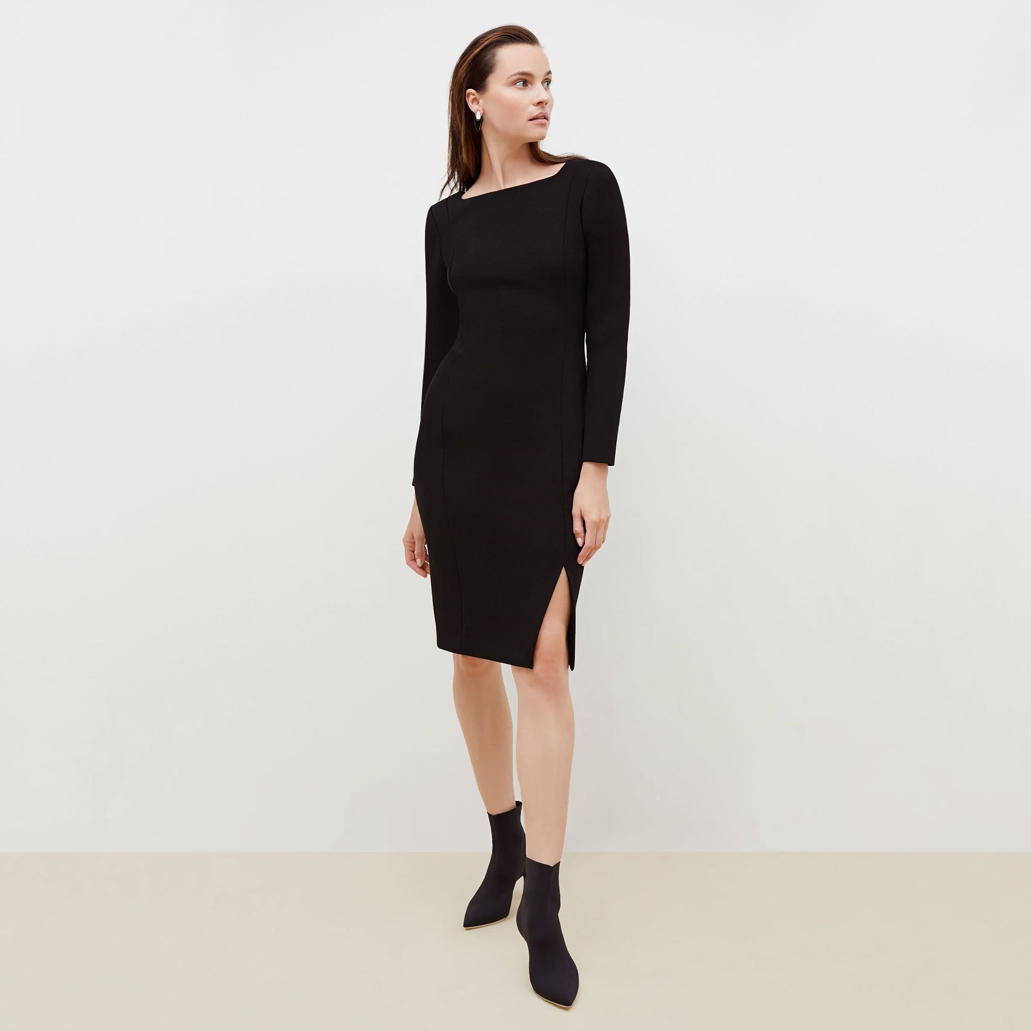 Front image of a woman standing wearing the Joanna Dress-Worth in Black