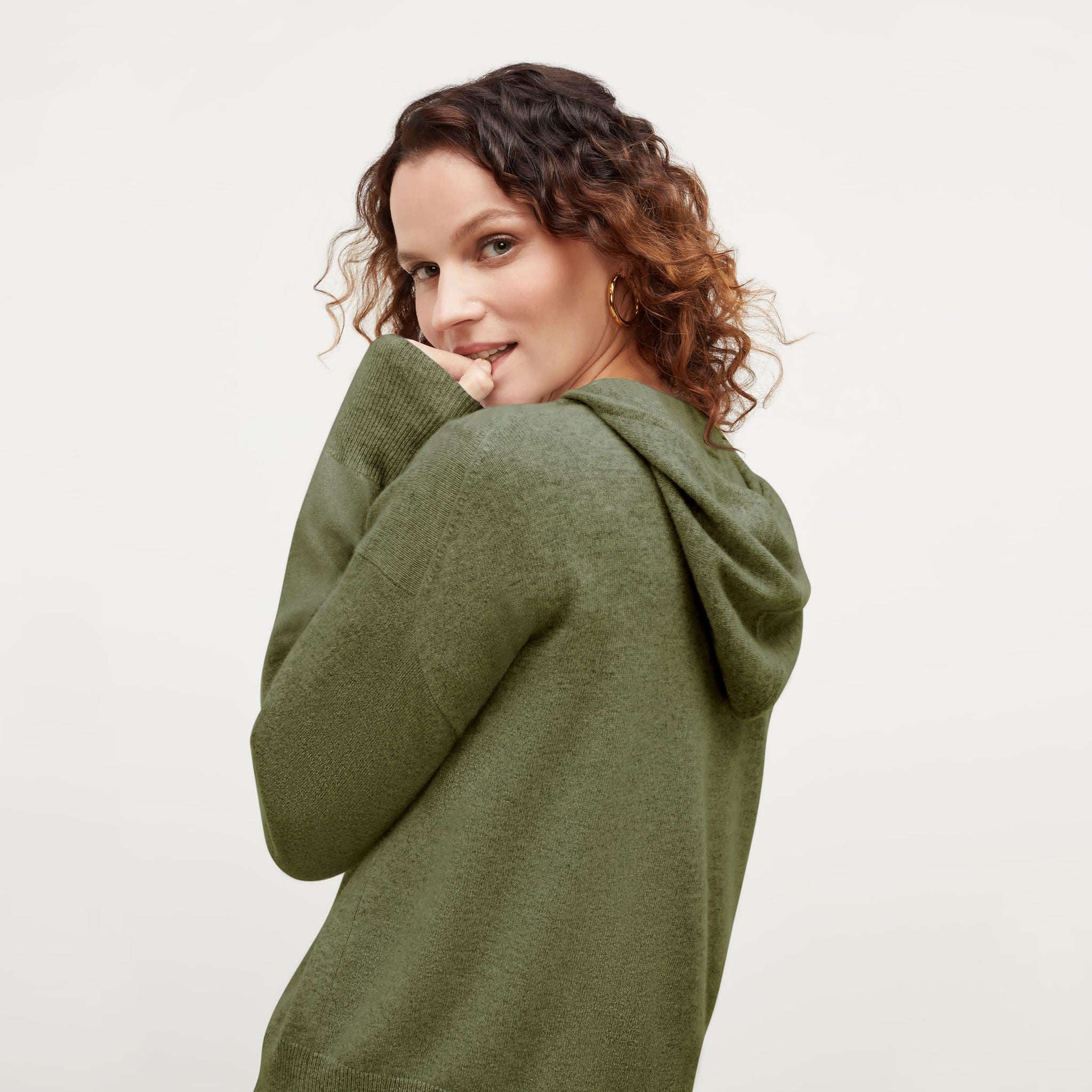 Back image of a woman standing wearing the Judith Hoodie—Cashmere in Olive 