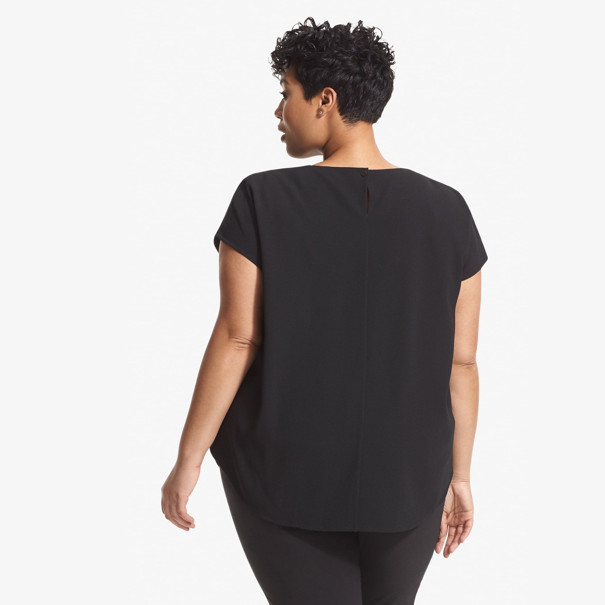 Back image of a woman standing wearing the Didion top in black