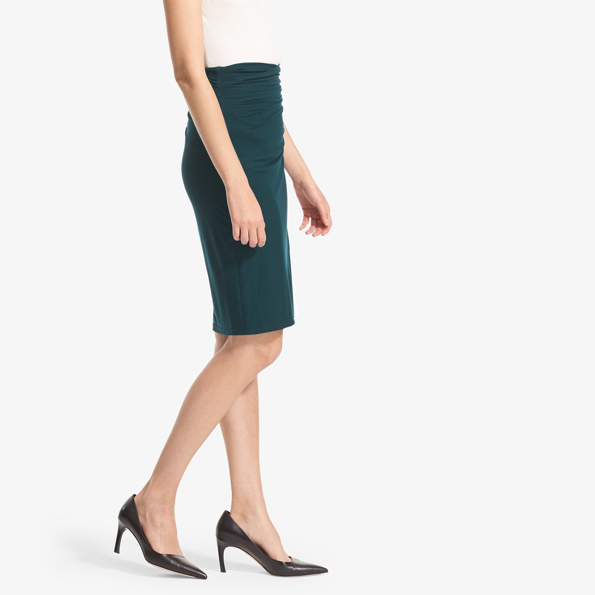 Side image of a woman standing wearing the Soho Skirt in Rainforest
