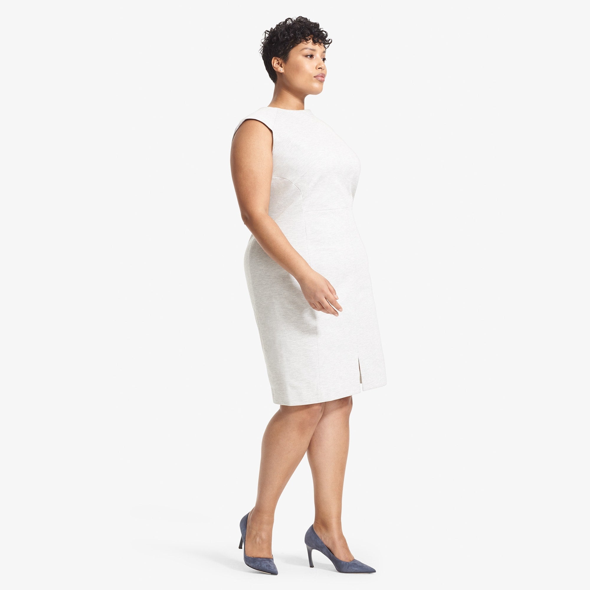 Side image of a woman standing wearing the Katie Dress--Twill Ponte in Light Heather Gray