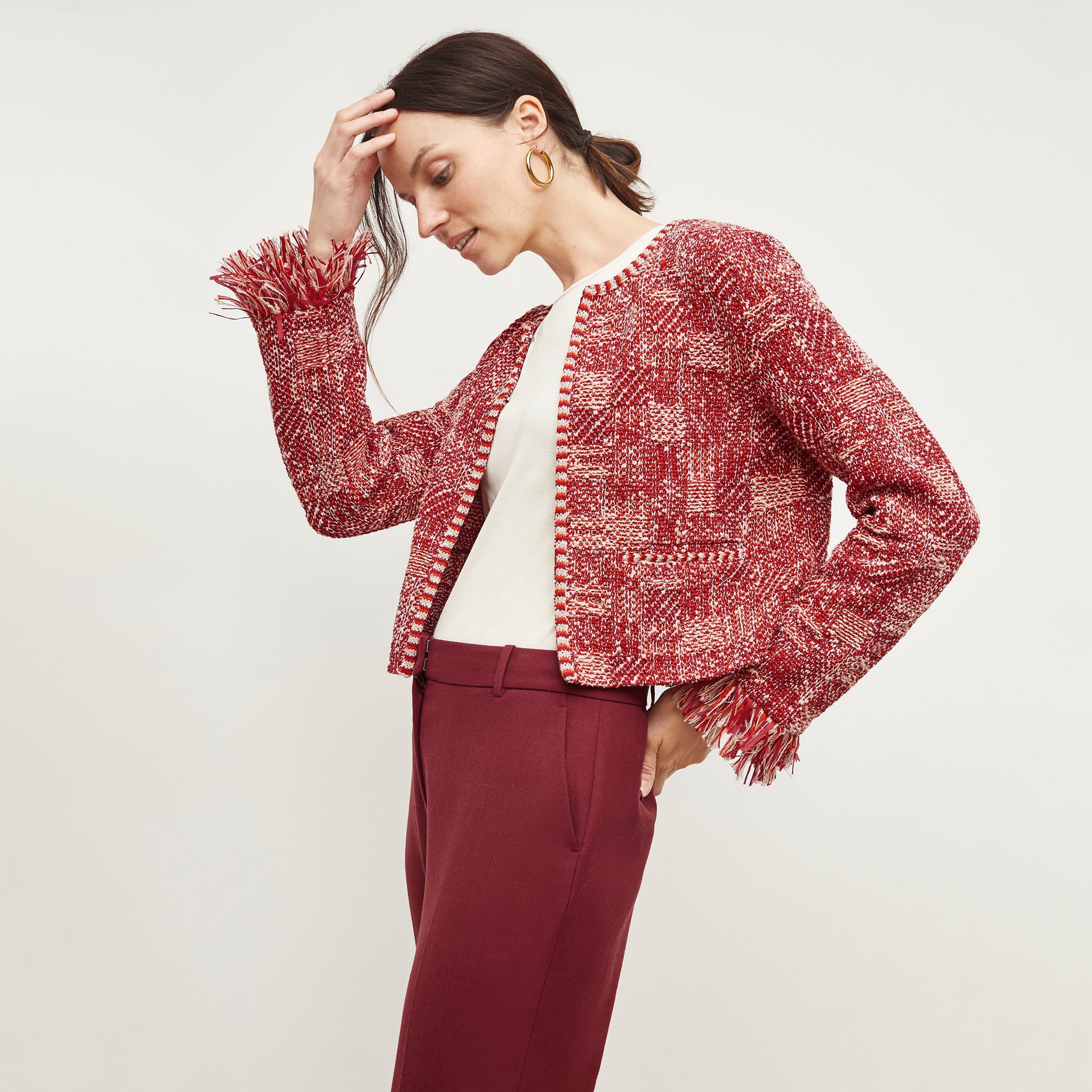 Side image of a woman standing wearing the Lilia Jacket—Interweave in Red Multi