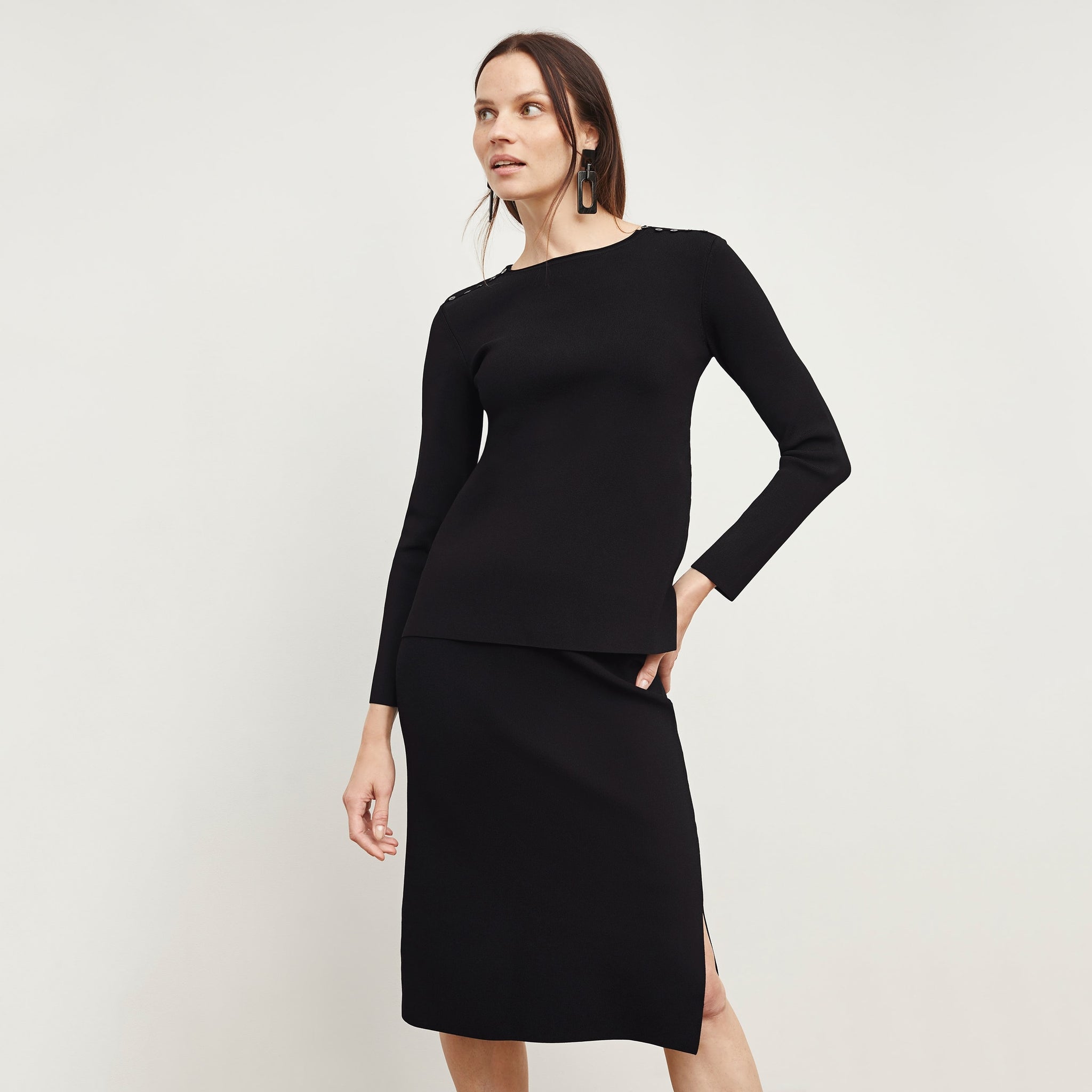 Front image of a woman standing wearing the Malin Top—Jardigan Knit in Black