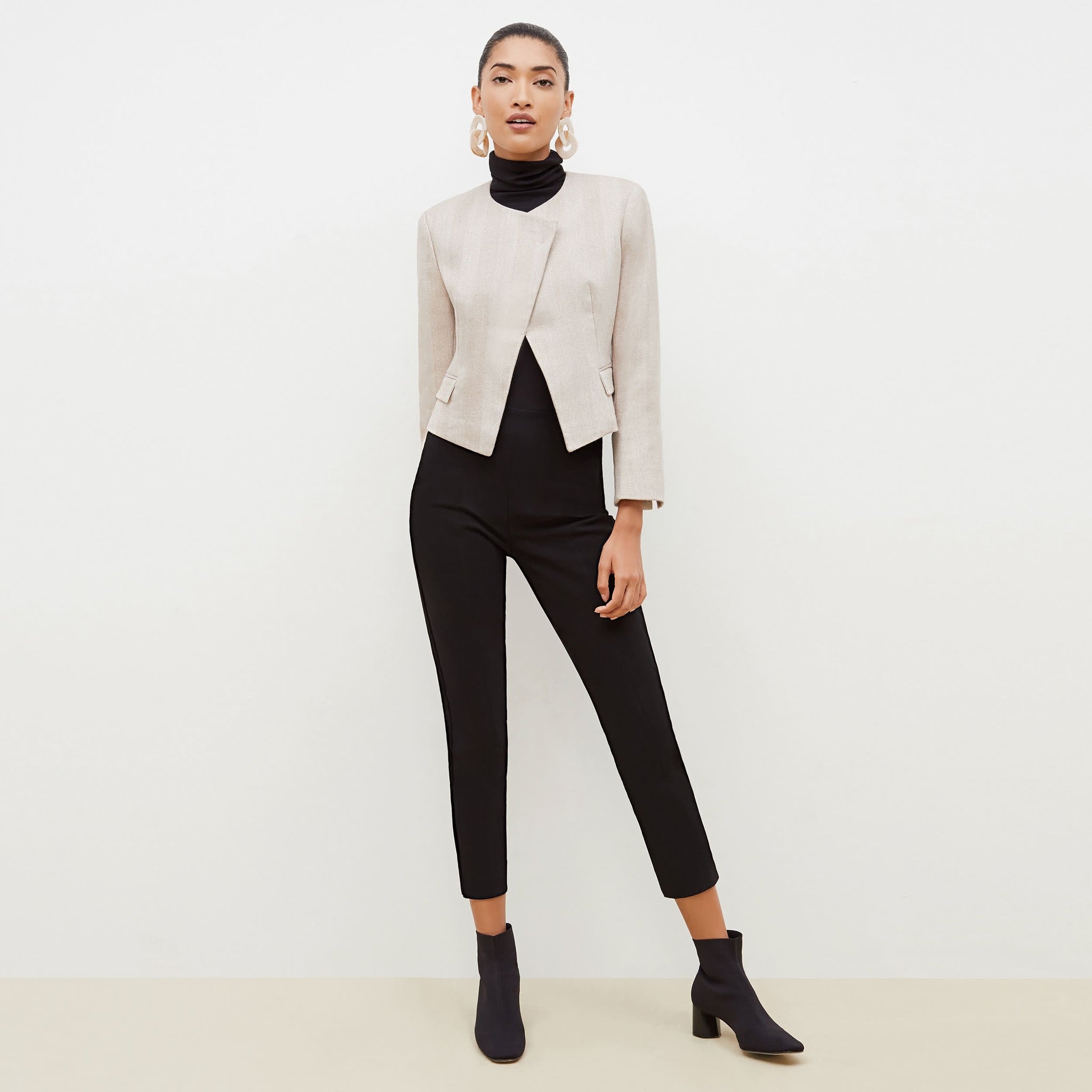 Front image of a woman standing wearing the Marais pant in black 